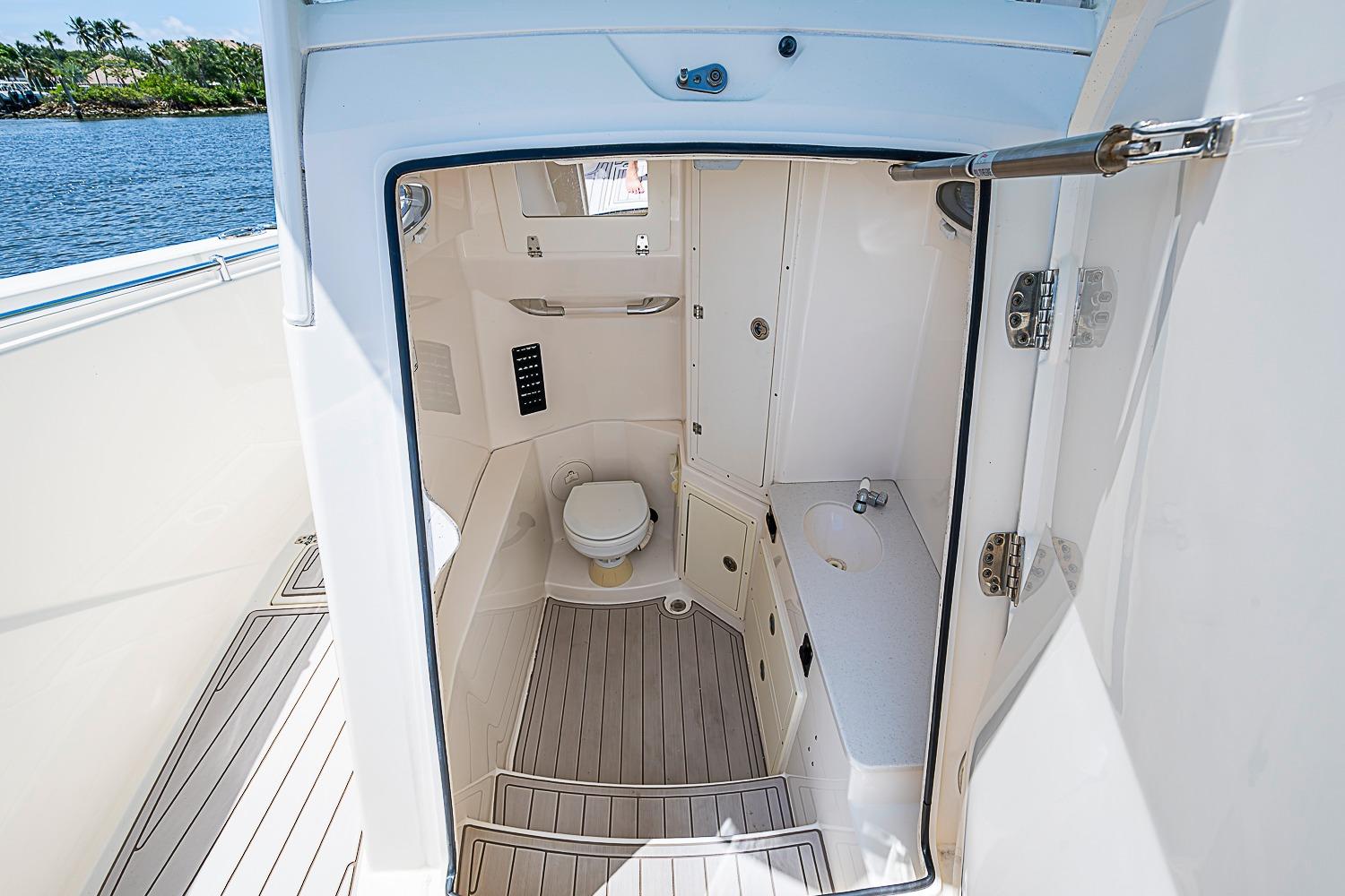 2019 Cobia 320 Center Console boat interior with toilet and sink.