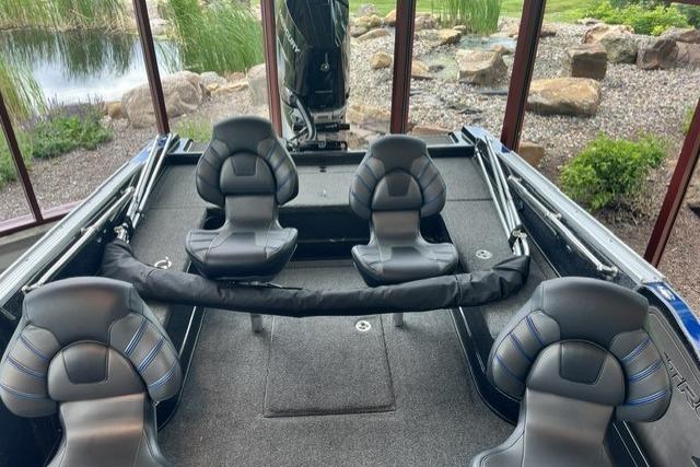 2025 Nitro ZV21 Pro boat interior with four cushioned seats, set in a scenic outdoor environment.