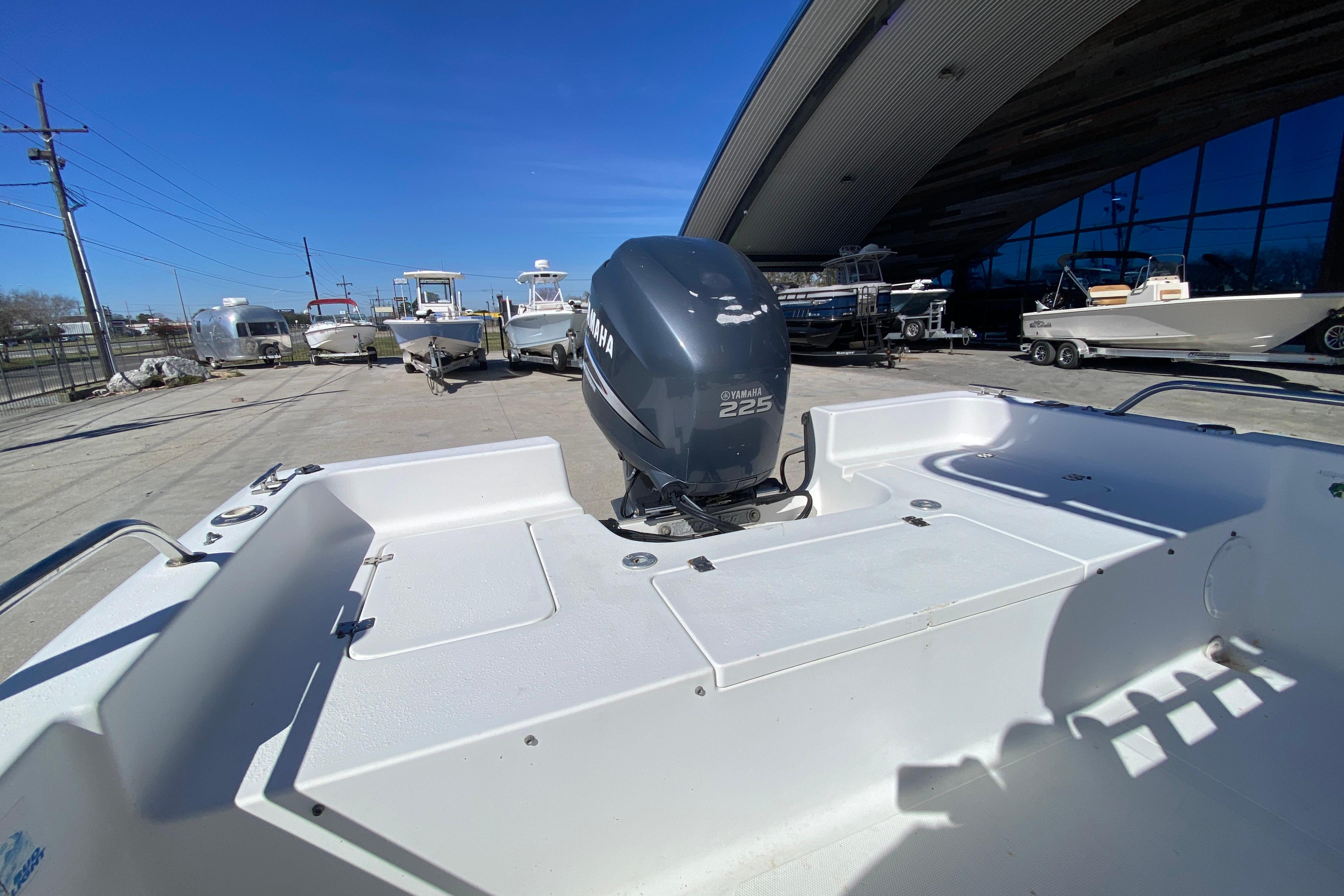 2005 Sea Pro SV2400CC Bay Boat with Yamaha 225 engine, parked outdoors.