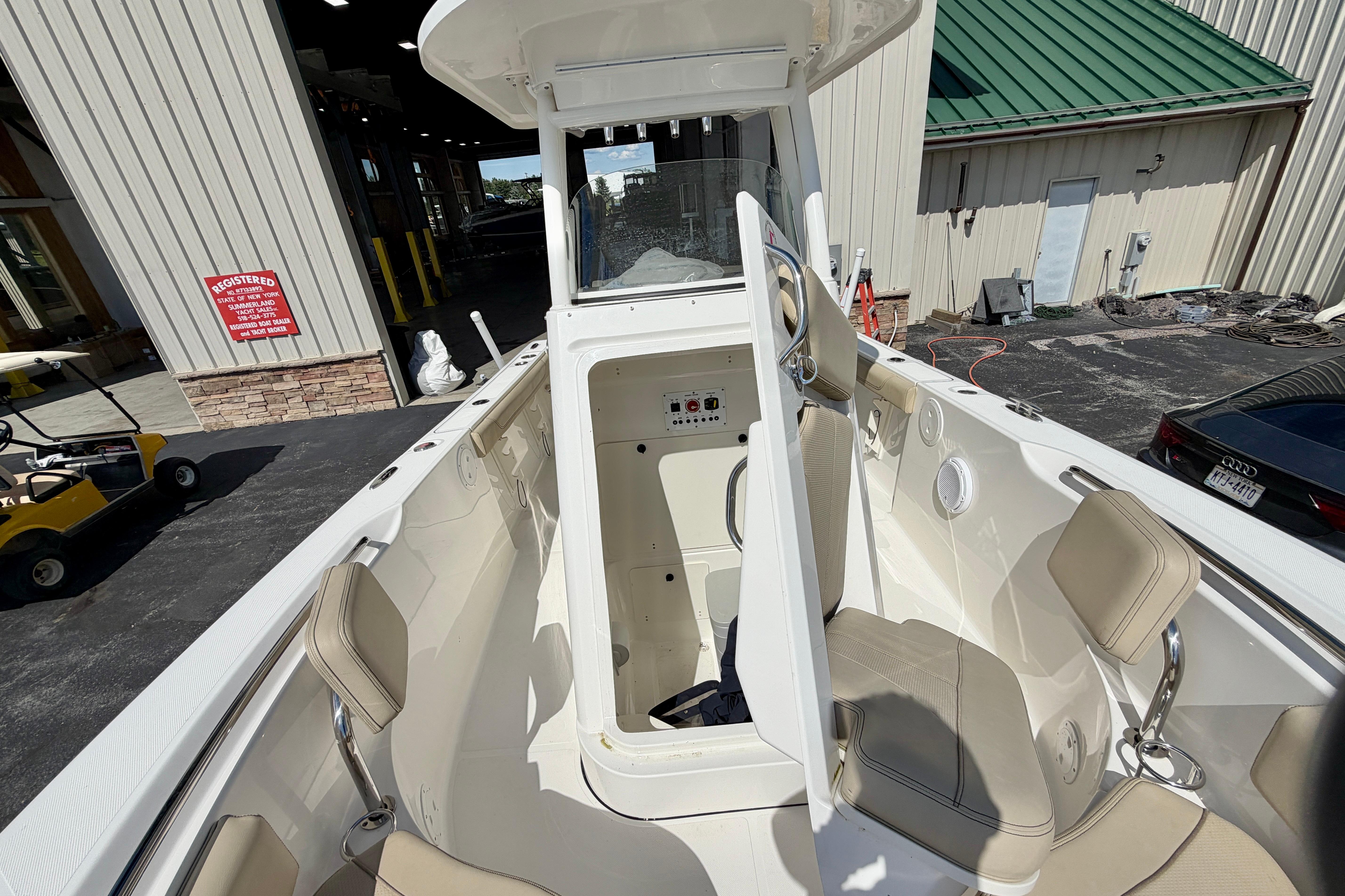 2020 Pursuit C 238 Center Console boat interior with beige seating and storage compartment.
