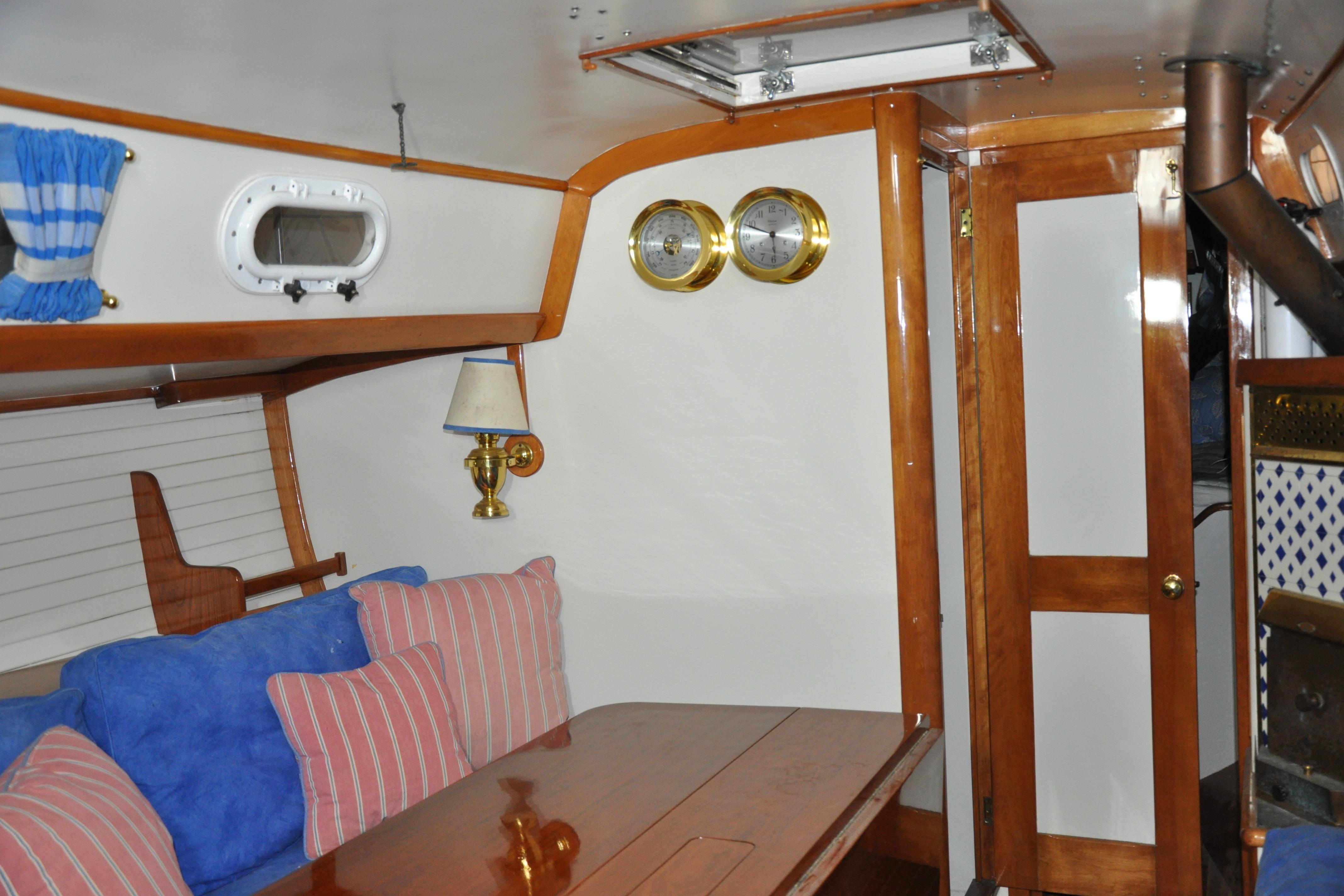 Interior of a 1970 Hinckley Bermuda 40 sailboat with wood accents and nautical decor.