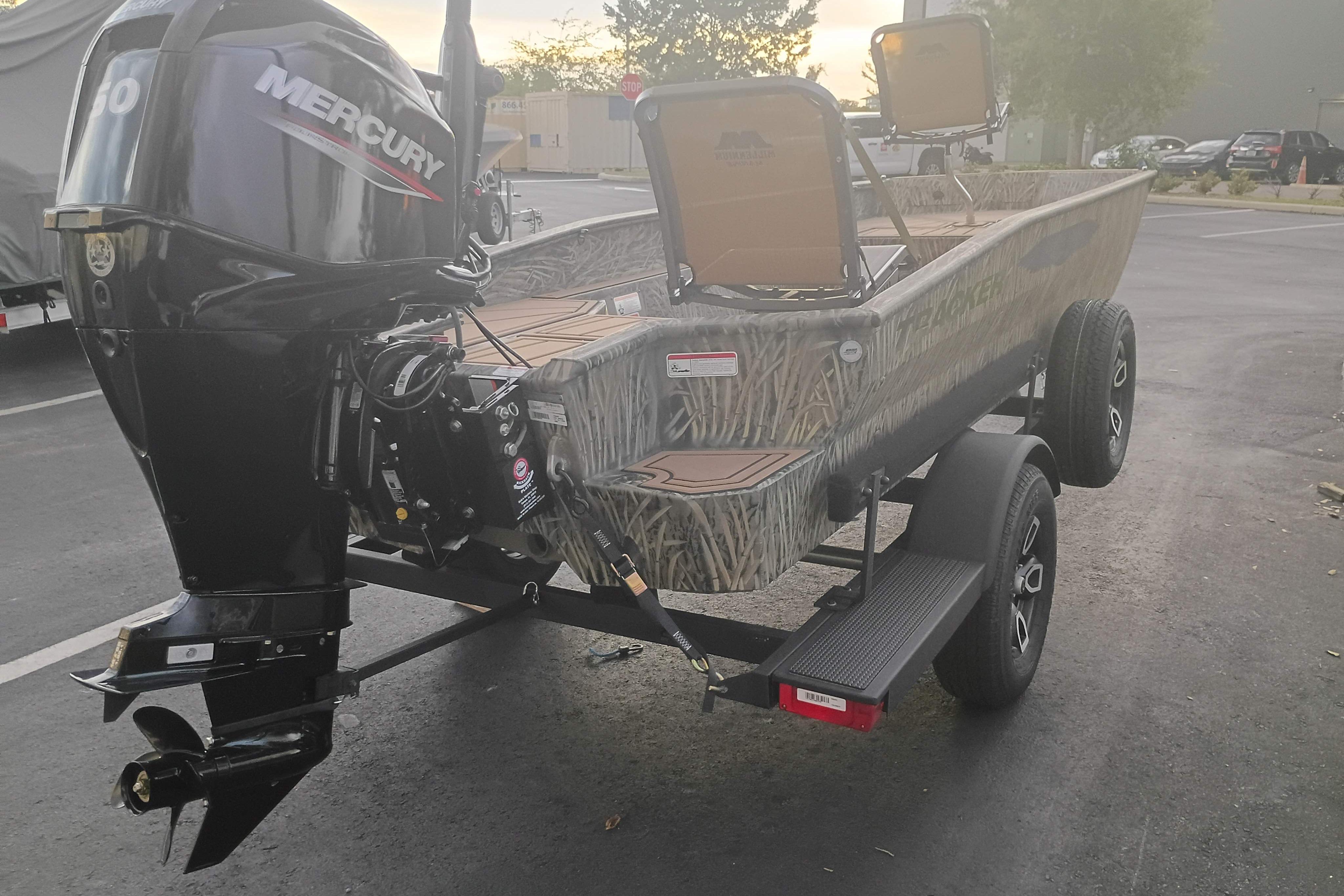 2026 Tracker Grizzly 1650 T Prairie Wings Edition boat with Mercury outboard motor on trailer.