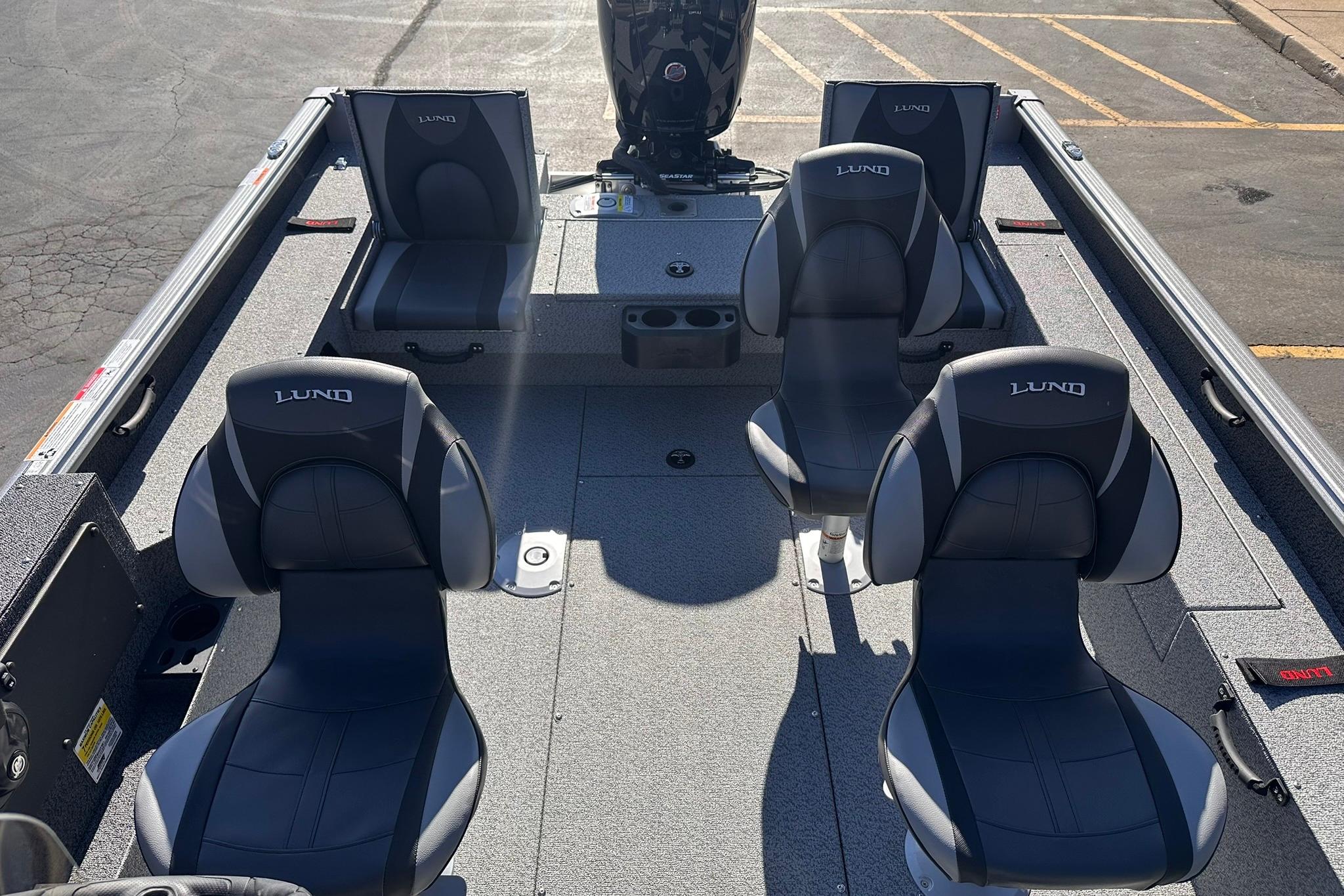 2026 Lund 1875 Impact XS SS boat interior with four black seats.