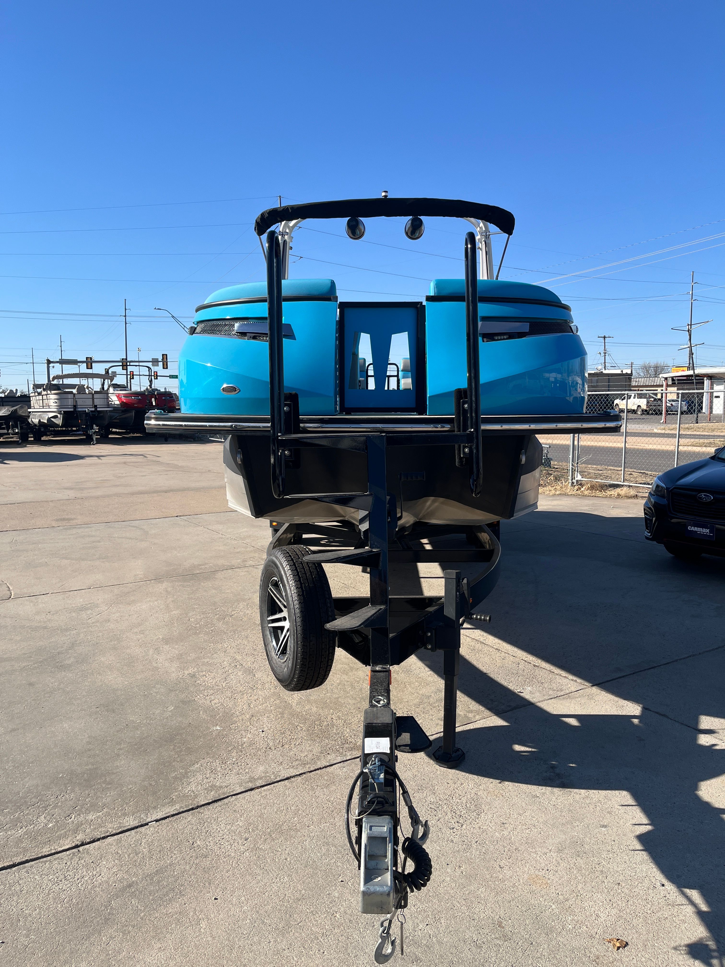 2023 Montara Surf Boss 2.0 boat on trailer, blue sky.