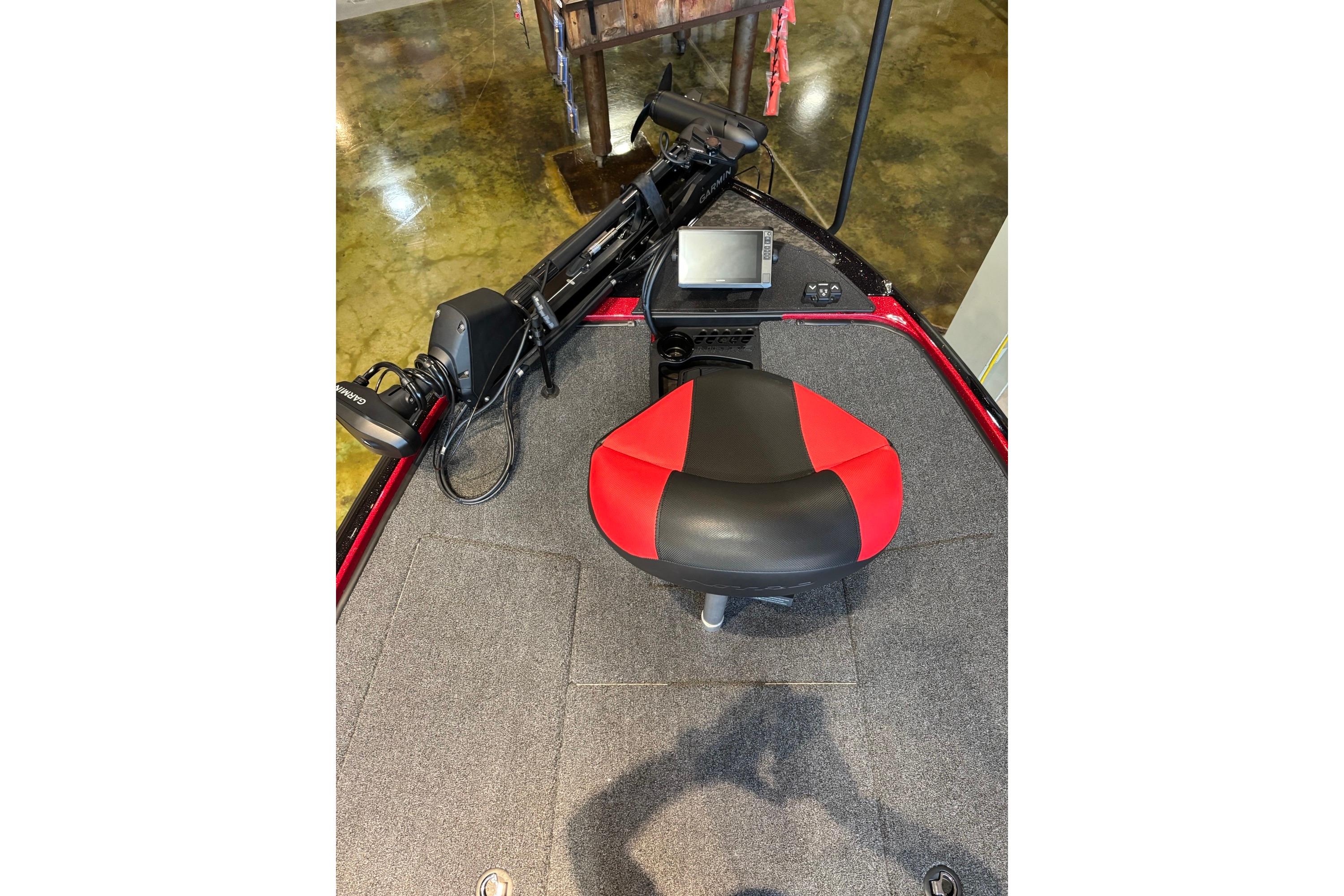 2026 Nitro Z20 XL Pro boat interior with red and black seat, control panel, and equipment.