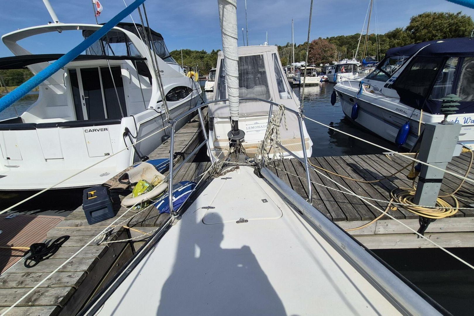 1984 Mirage Yachts 35 sailboat docked among other boats in a marina.