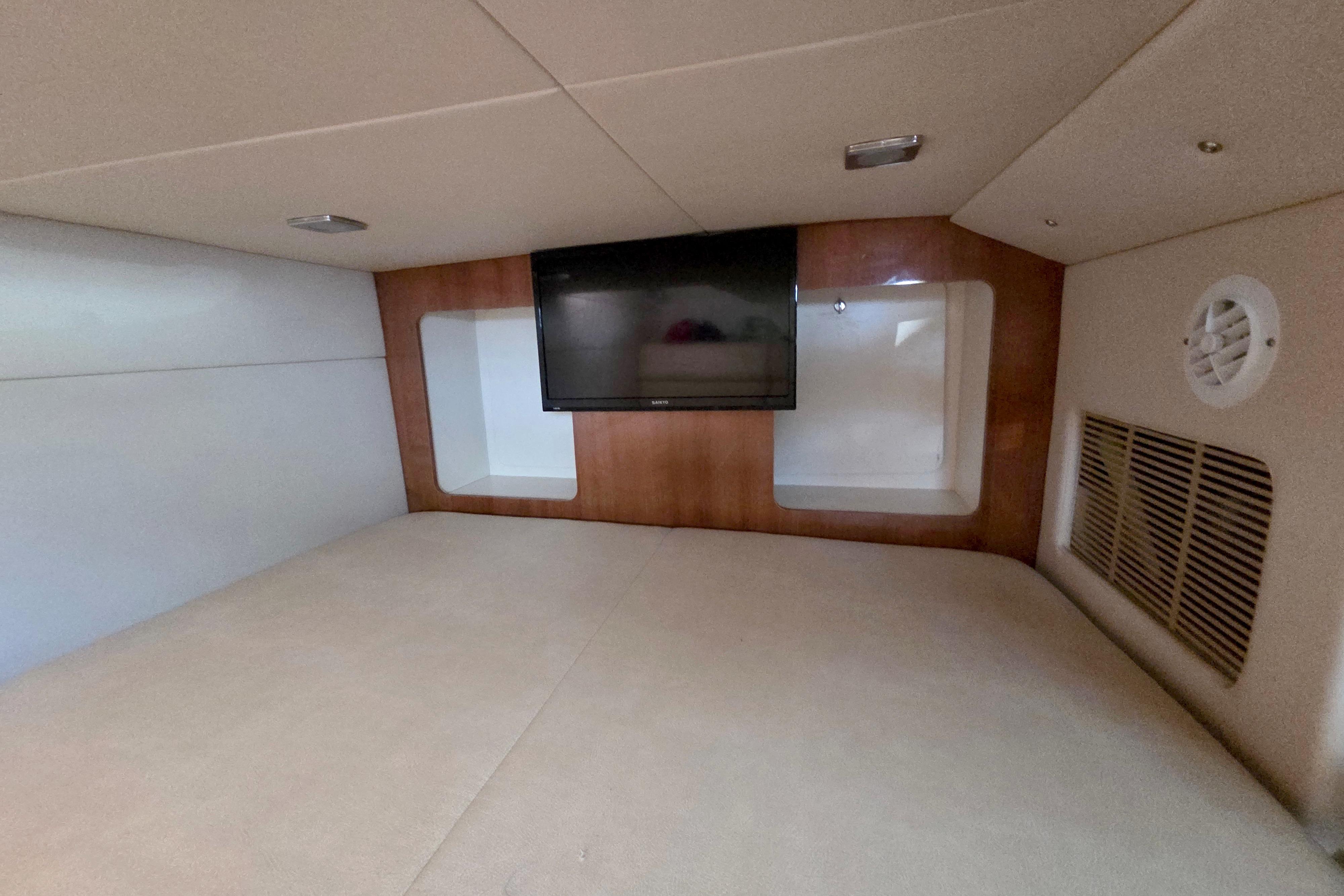 2015 Formula 350 Crossover Bowrider cabin interior with TV and wood paneling.