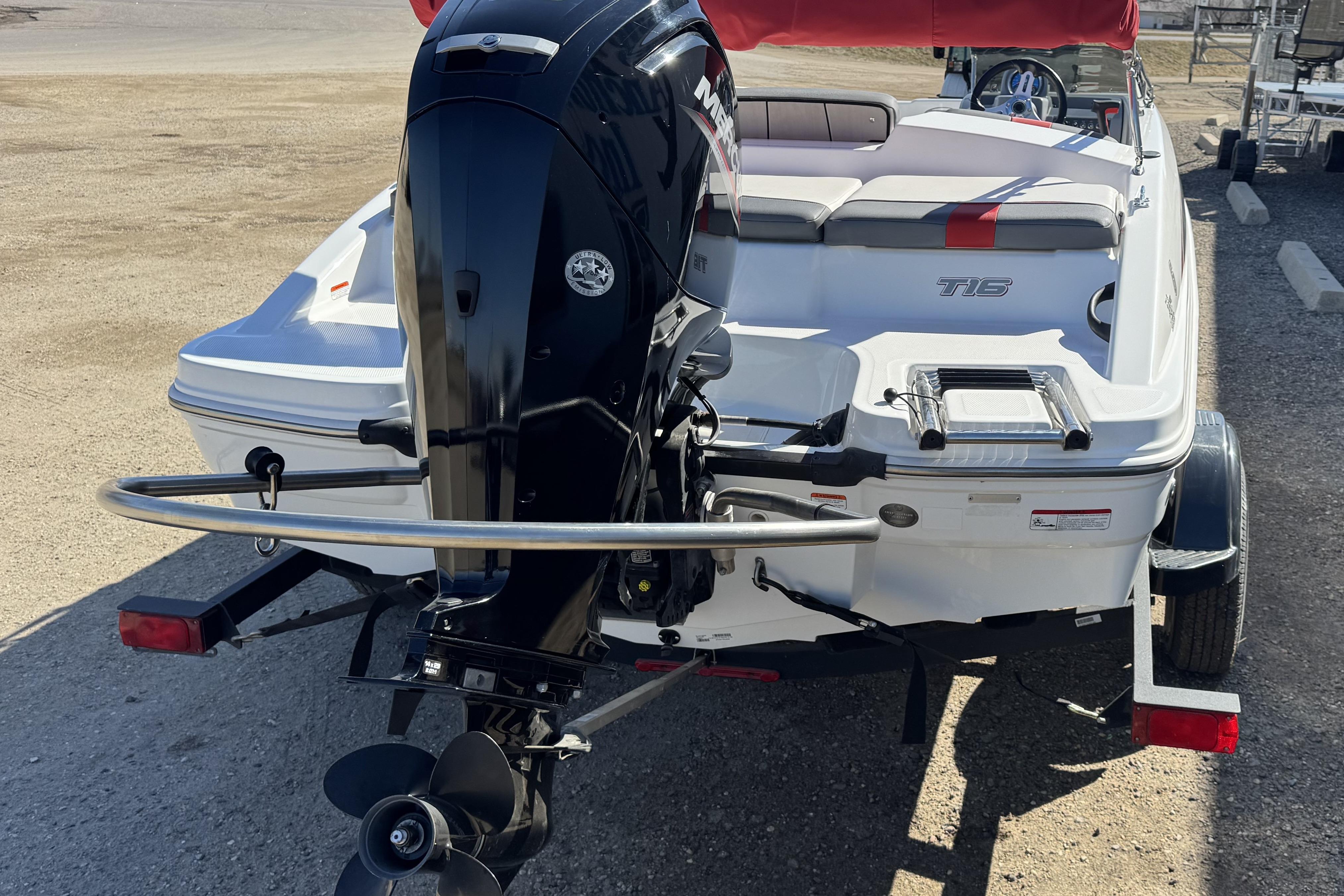 2021 Tahoe T16 boat with outboard motor on trailer, rear view.