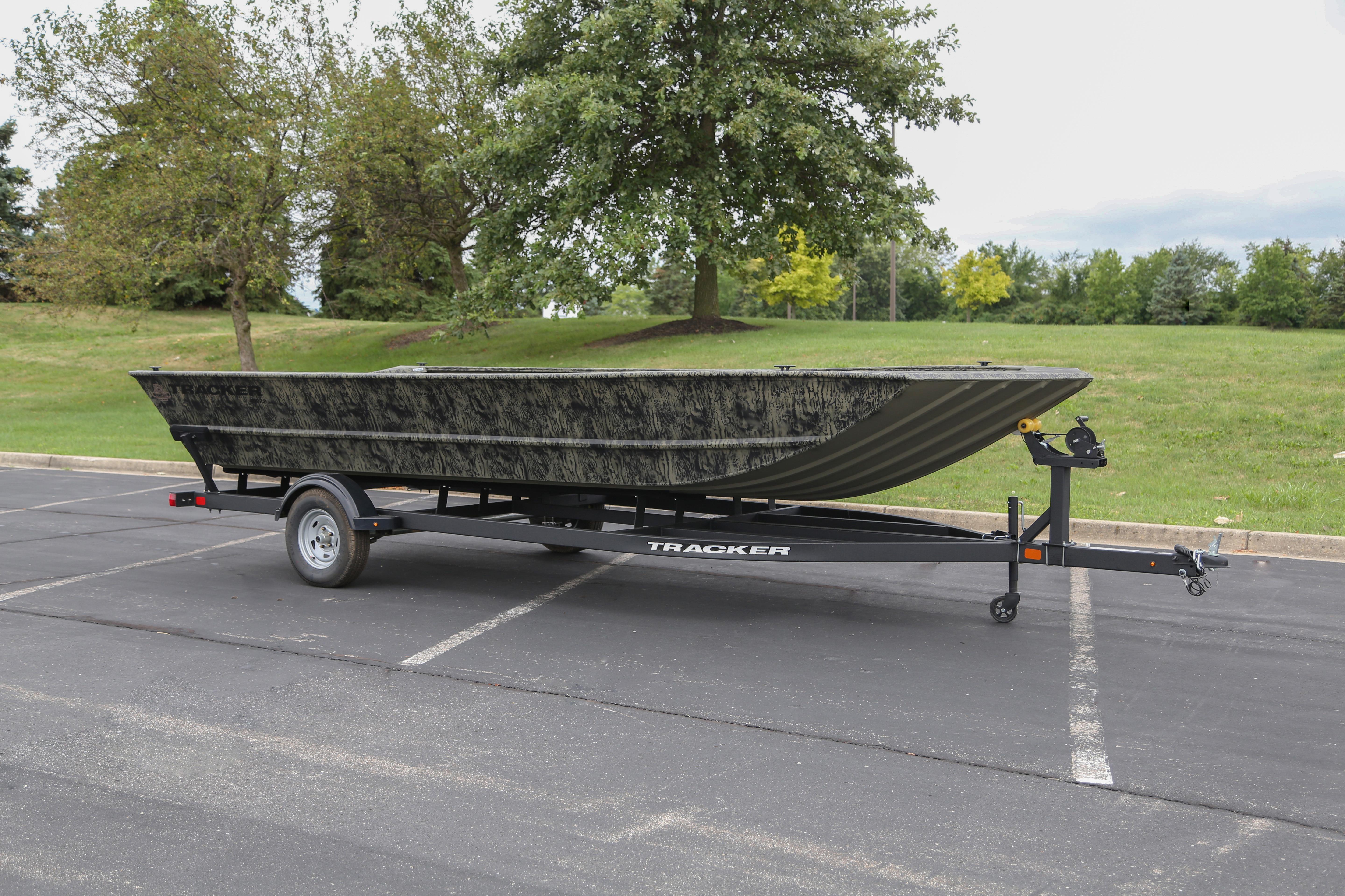 2026 Tracker GRIZZLY 2072 Utility boat on trailer in parking lot.