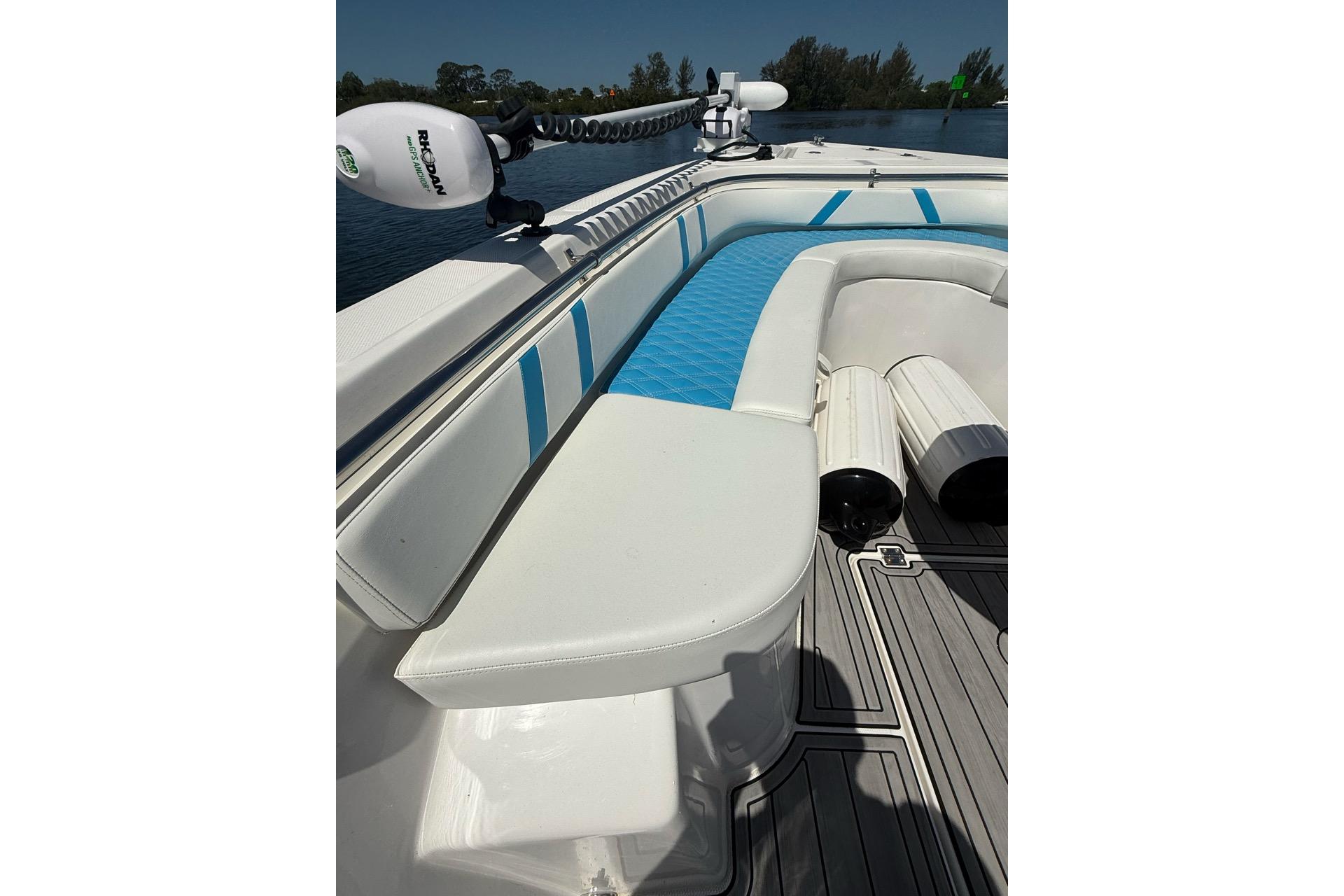 Custom Infusion 34 CC 2021 boat interior with white and blue seating, docked on water.