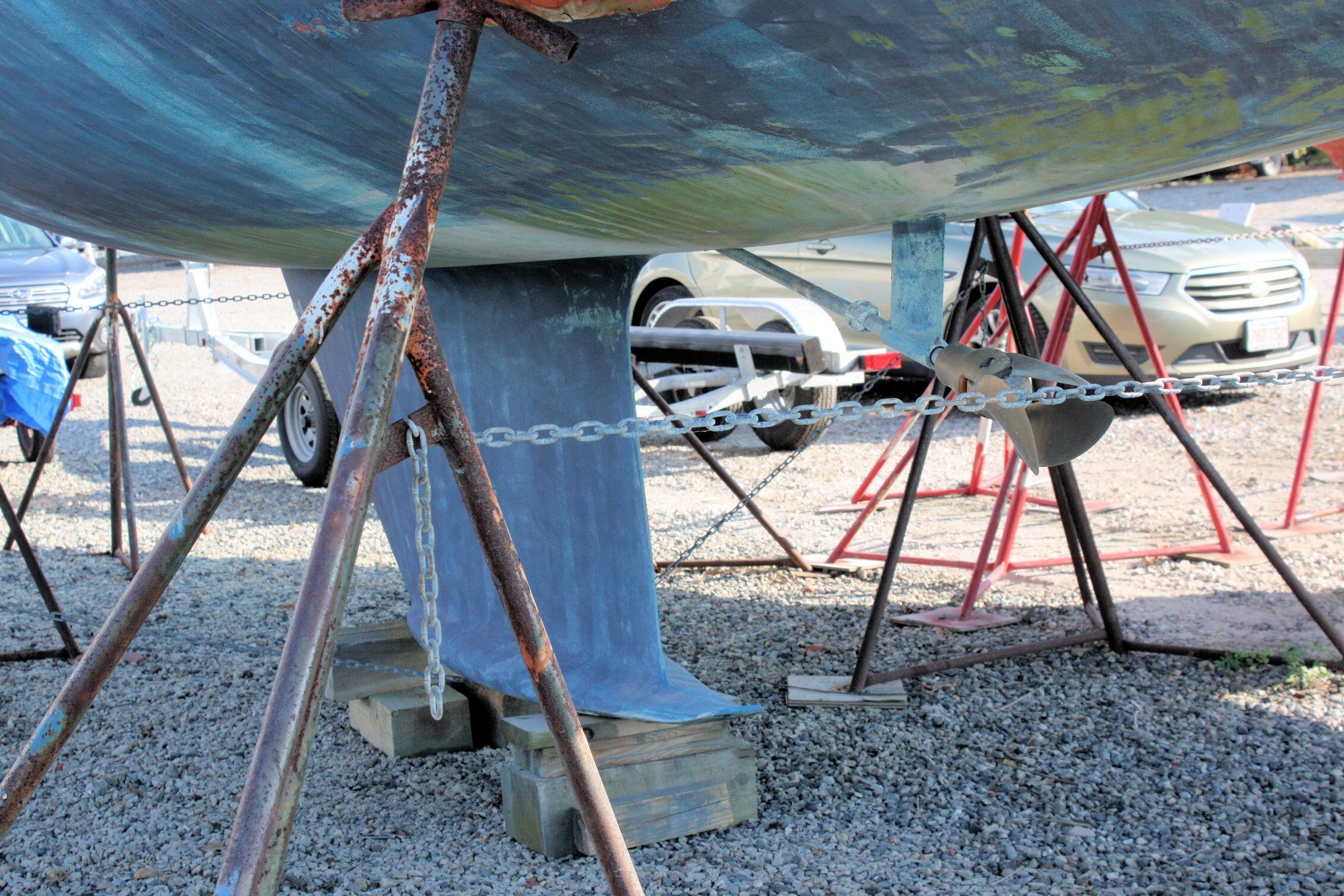 1987 Ericson 38-200 sailboat keel and propeller on stands in a boatyard.