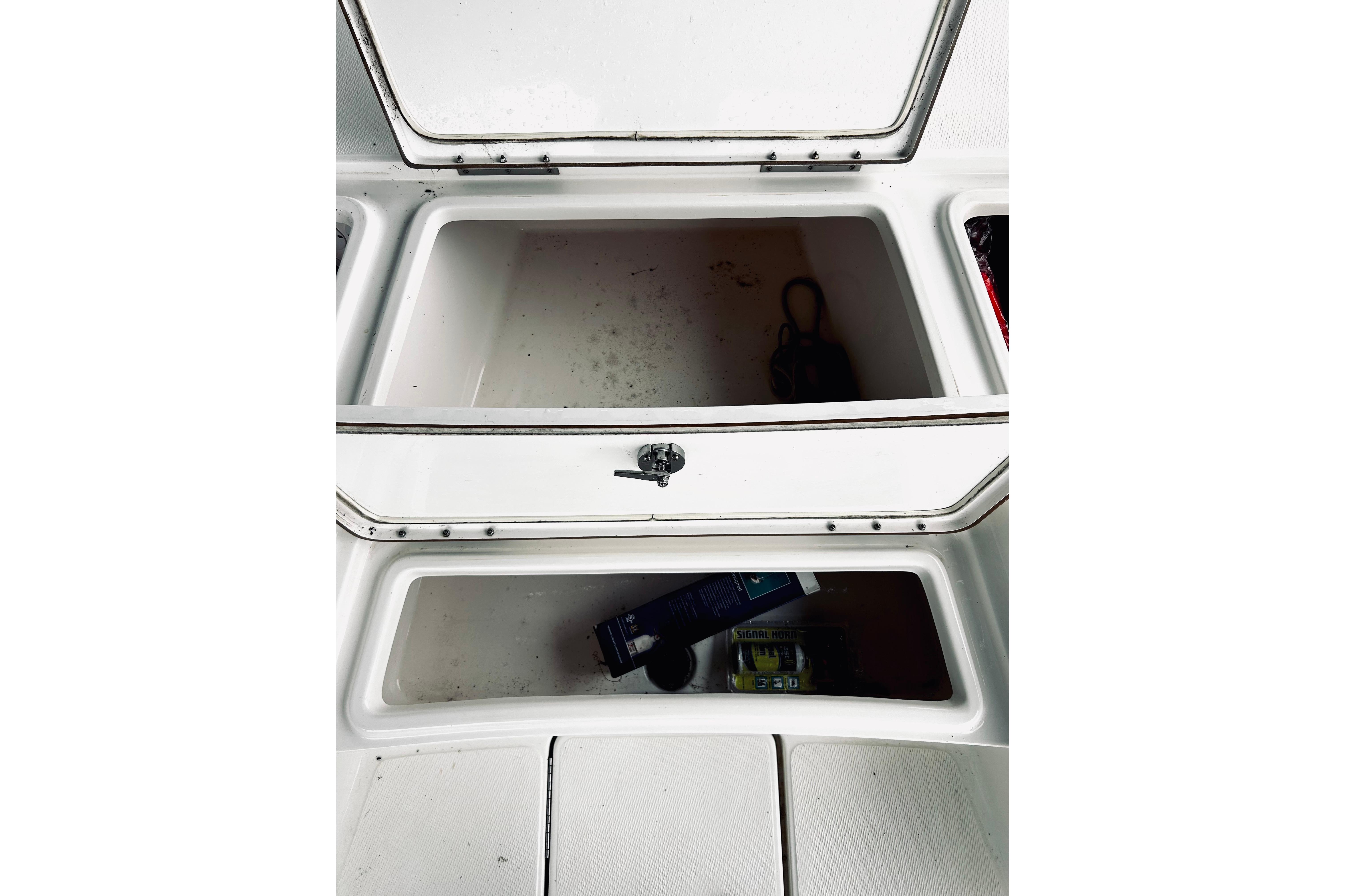 Open storage compartments on a 2017 Blue Wave 2200 PureBay boat.