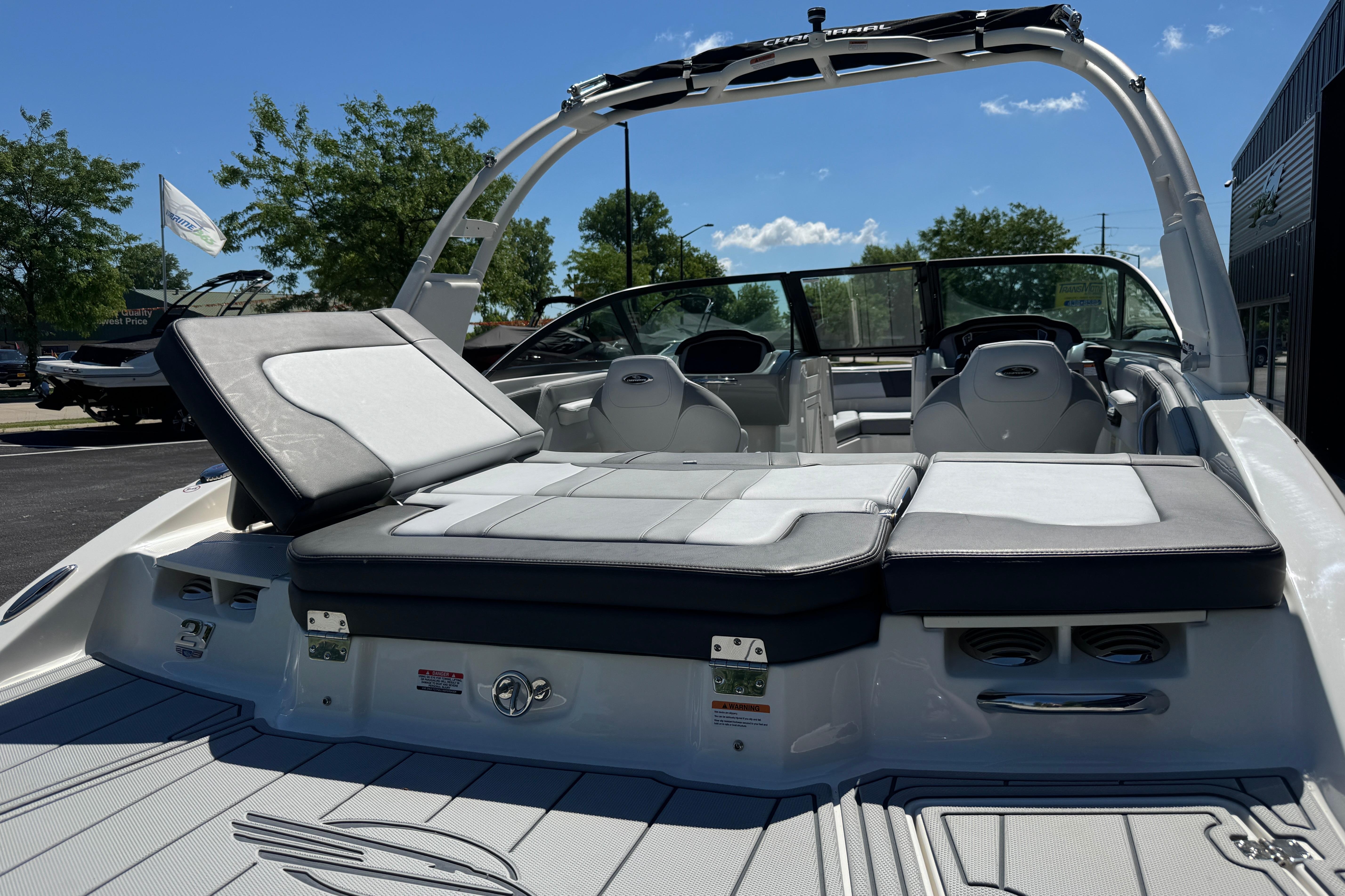 2026 Chaparral 21 SSi boat with sleek seating and modern design under a clear sky.