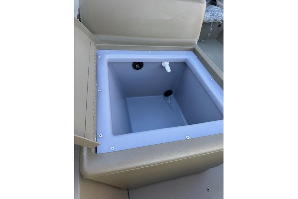 2026 Tracker Grizzly 1754 SC boat storage compartment, open lid, beige interior.