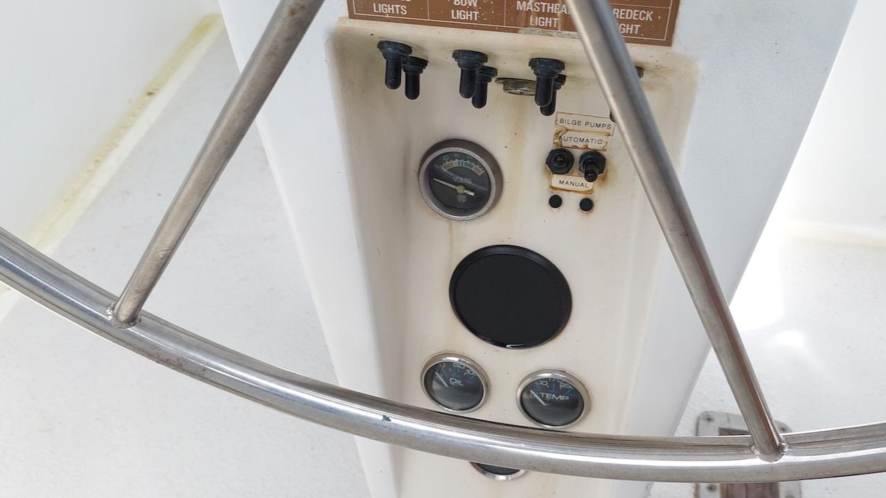 Control panel of a 1981 Morgan Out Island 41 sailboat with gauges and switches.