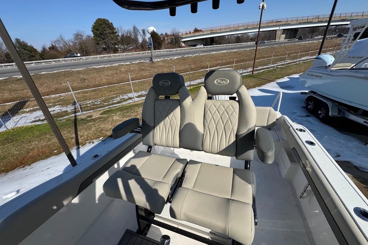 2026 Key West 239 FS boat interior with dual cushioned seats and armrests.