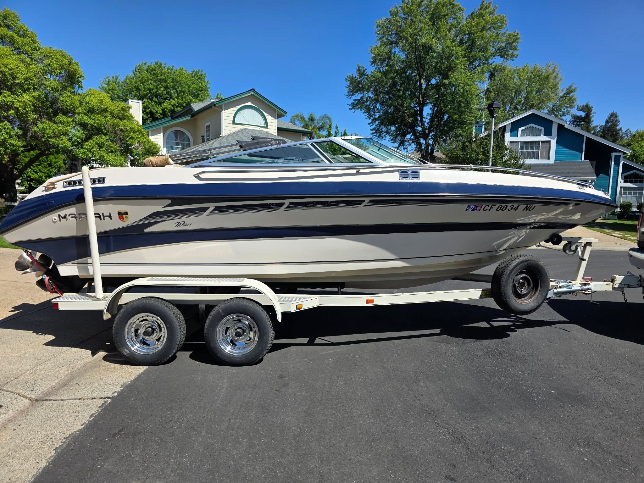 1996 Mariah Talari boat on trailer in residential area.