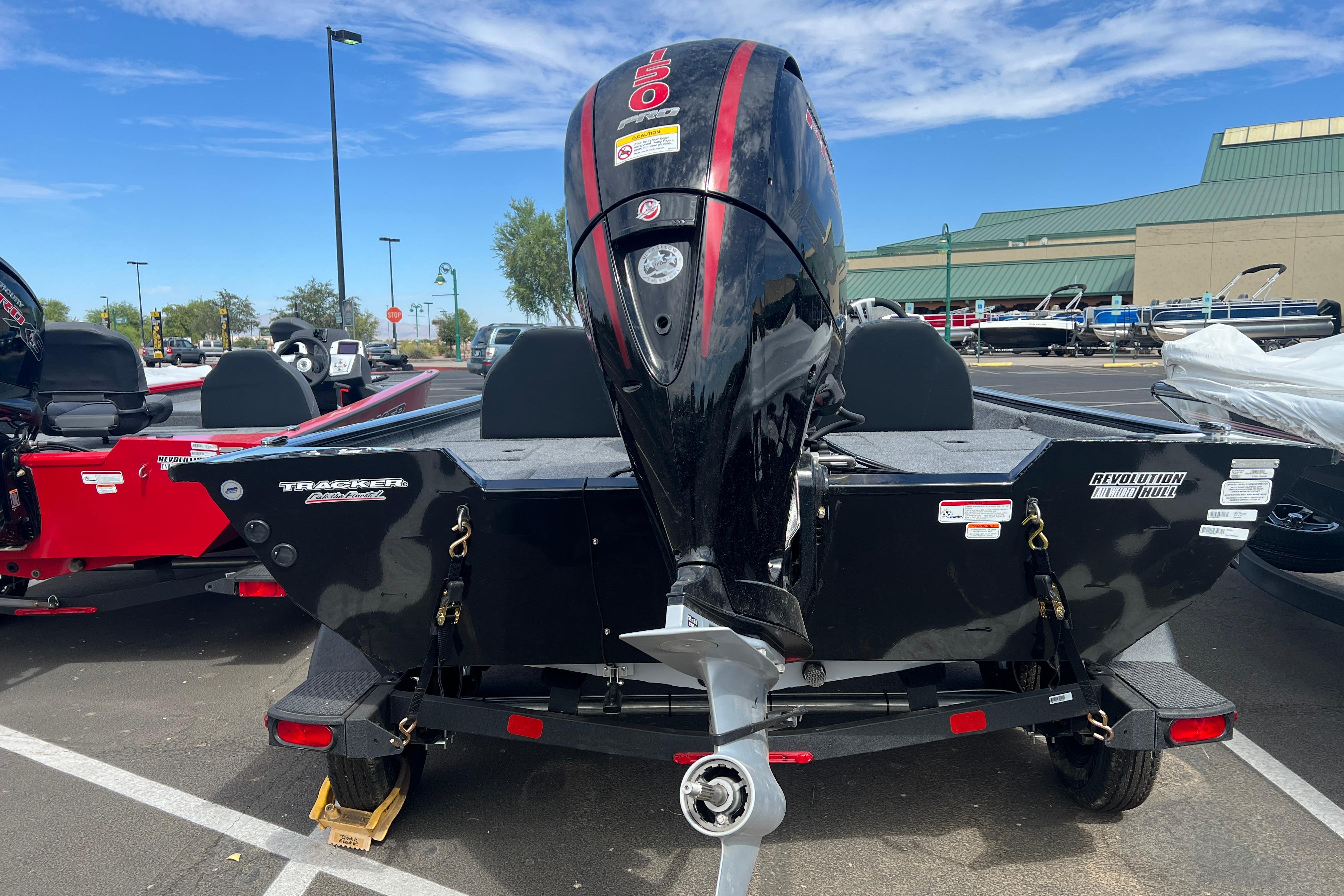 2026 Tracker Pro Team 195 boat with powerful outboard motor in a parking lot.