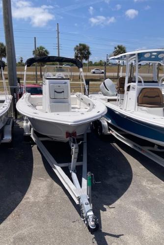 2025 Sea Pro 202 Center Console boat on trailer, parked outdoors under a clear sky.