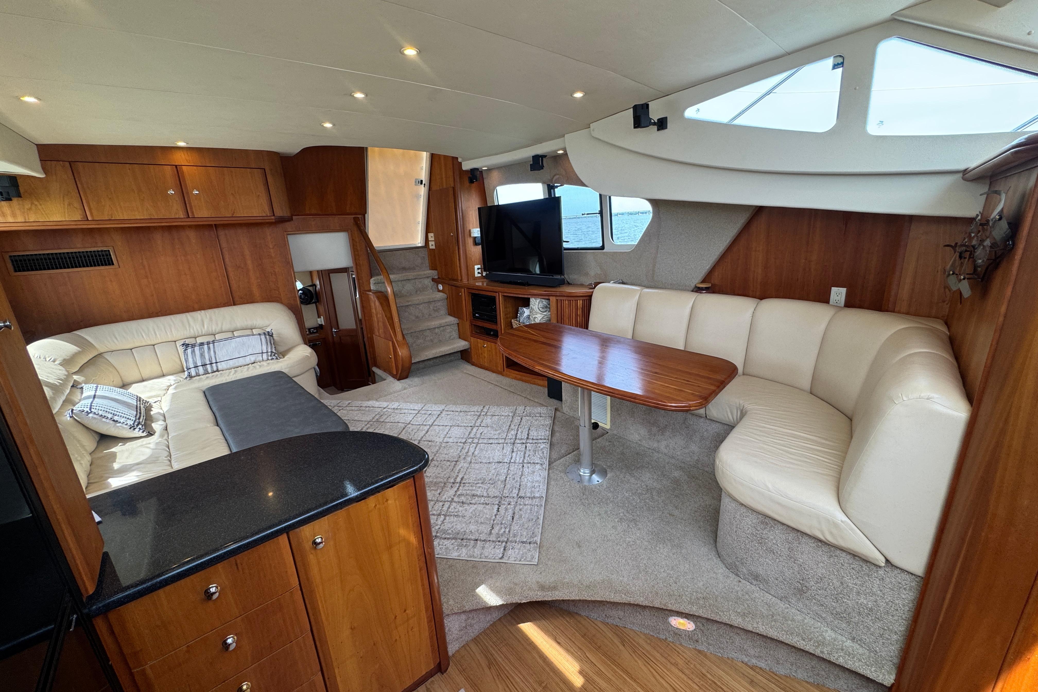 Luxurious interior of 2003 Silverton 39 Motor Yacht with plush seating and wooden finishes.