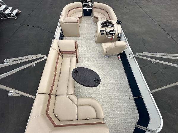 2018 South Bay S224CR pontoon boat with beige seating and steering wheel.