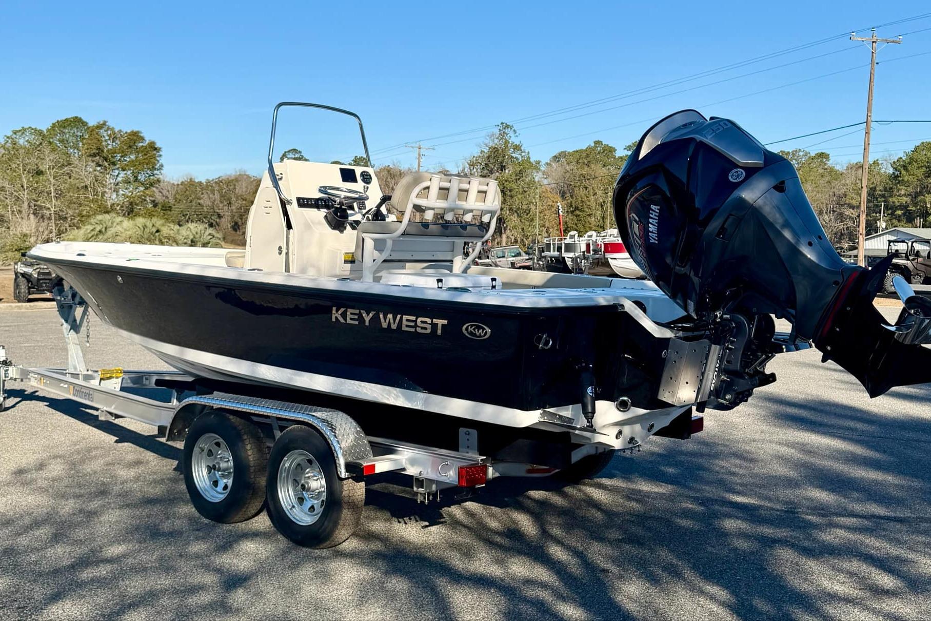 2026 Key West 210 Bay Reef boat on trailer, featuring sleek design and powerful outboard motor.