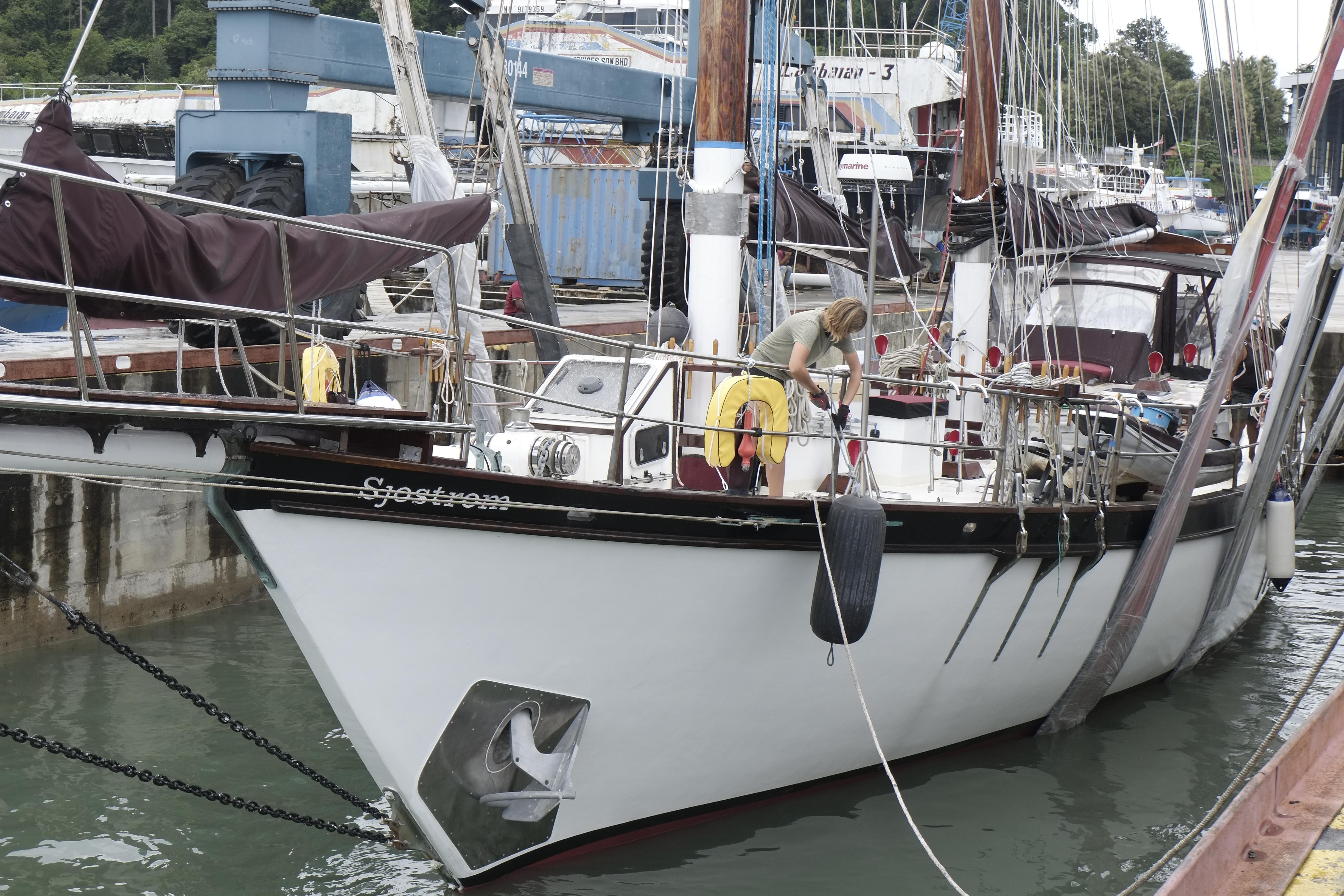 Custom Bud Macintosh schooner, 2006, docked at a marina with a person on deck.