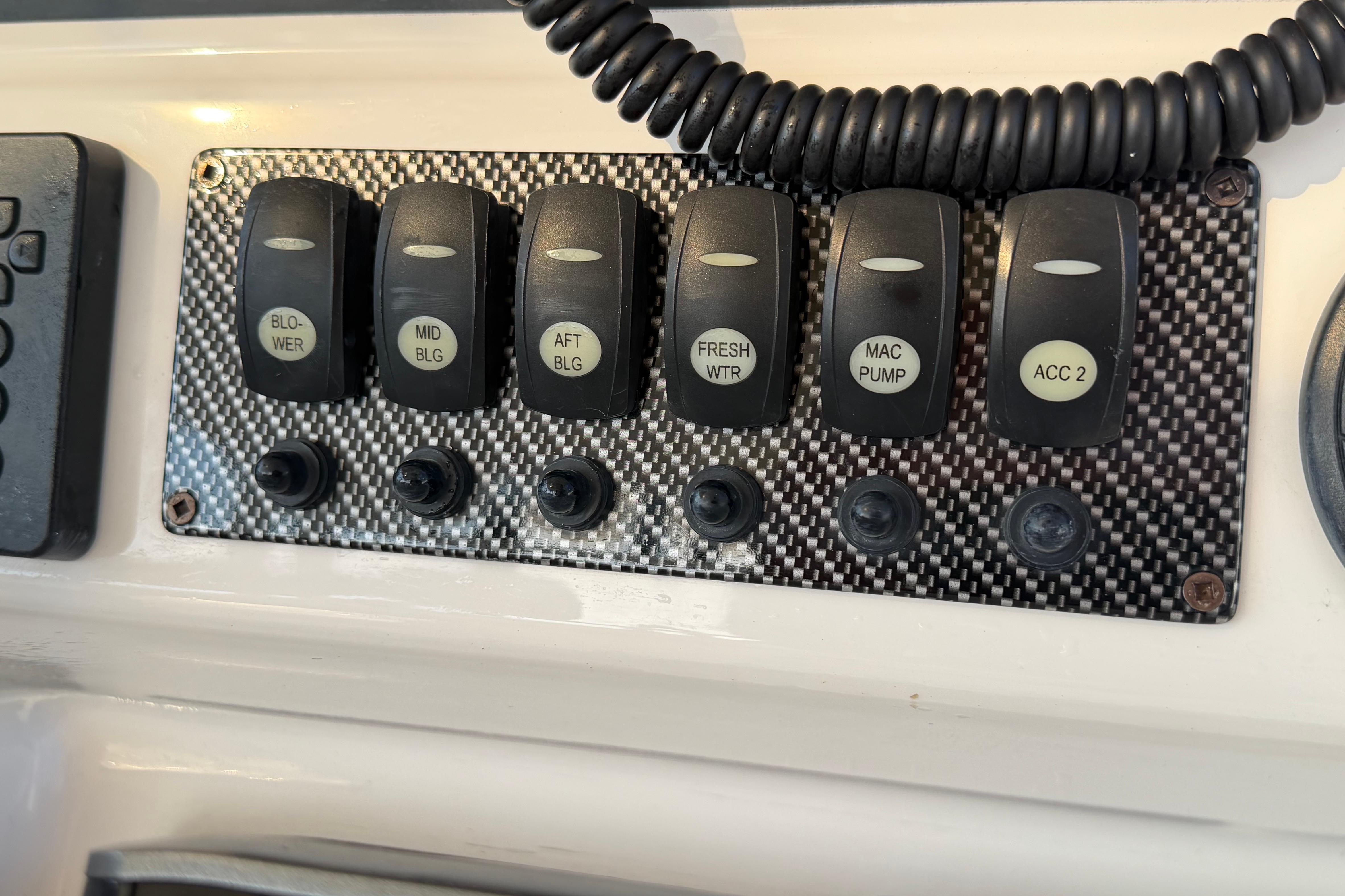Control panel with switches for blower, bilge, water, and accessories on a 2020 Solara S-250 CW.