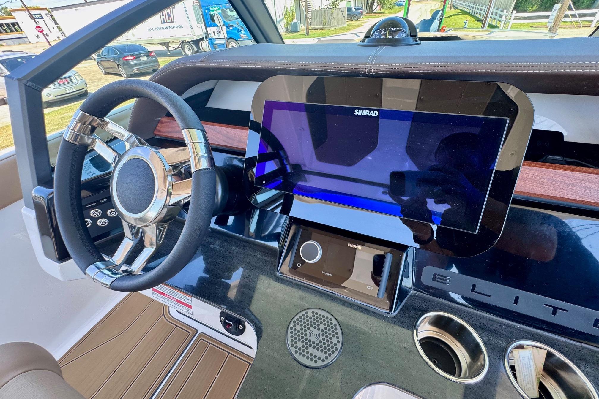 2026 Monterey Elite 27 OB dashboard with steering wheel and touchscreen display.
