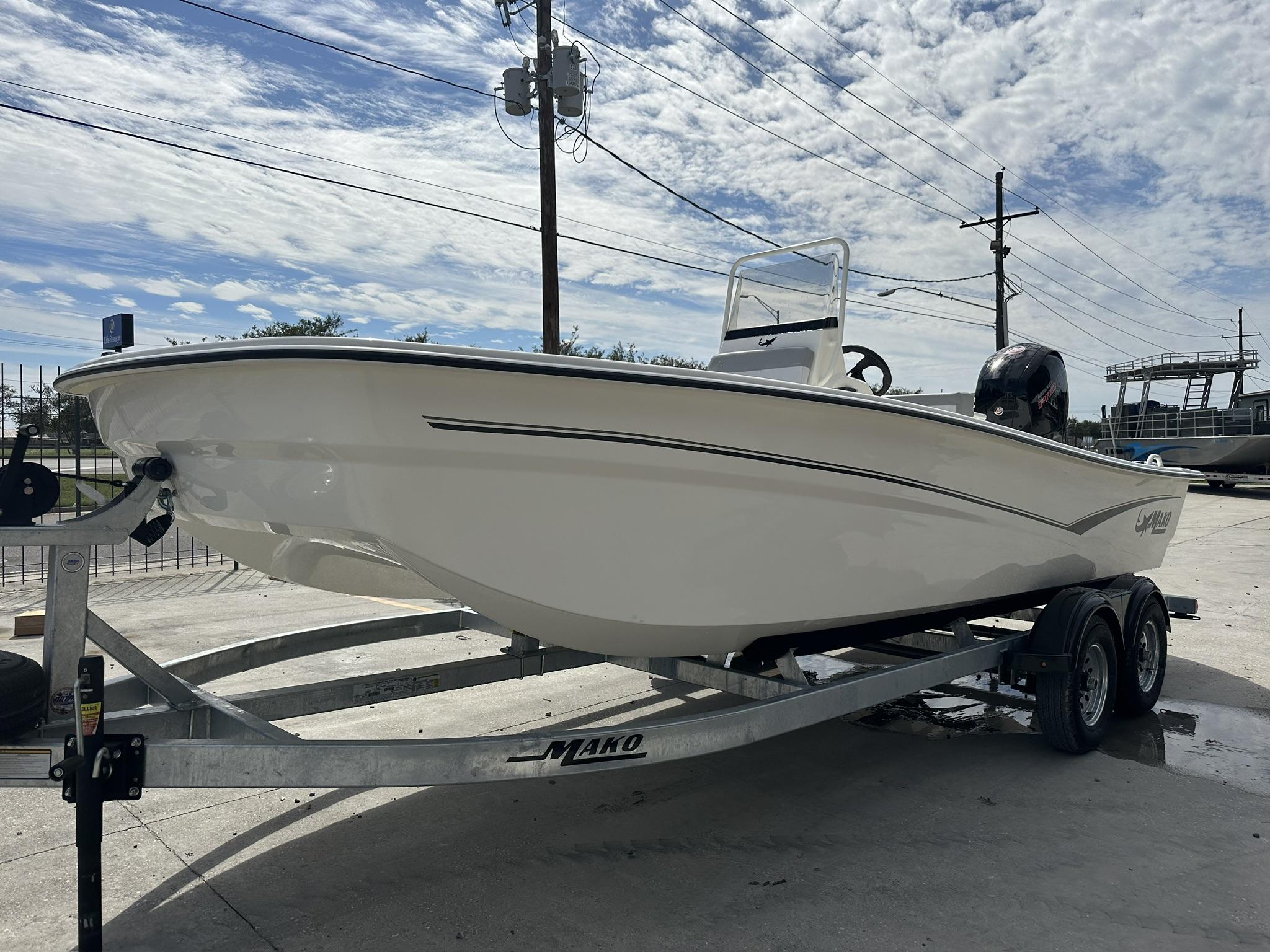 2024 Mako Pro Skiff 19 CC boat on trailer under cloudy sky.