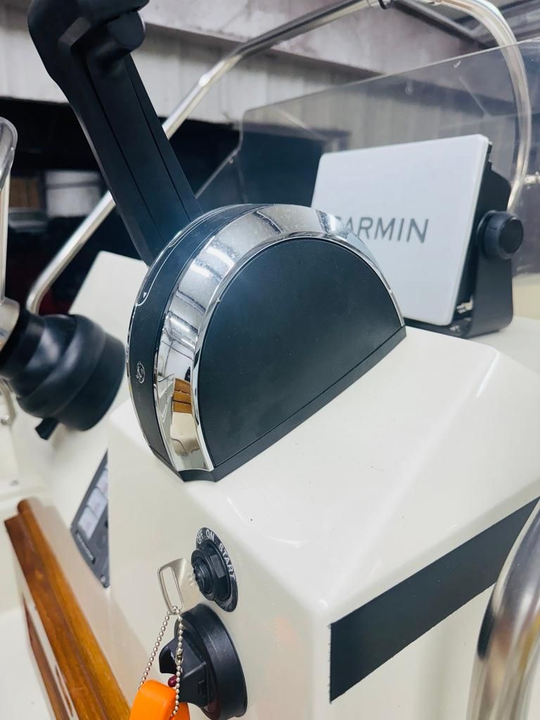 Close-up of a 1986 Boston Whaler 17 Montauk helm with Garmin device.