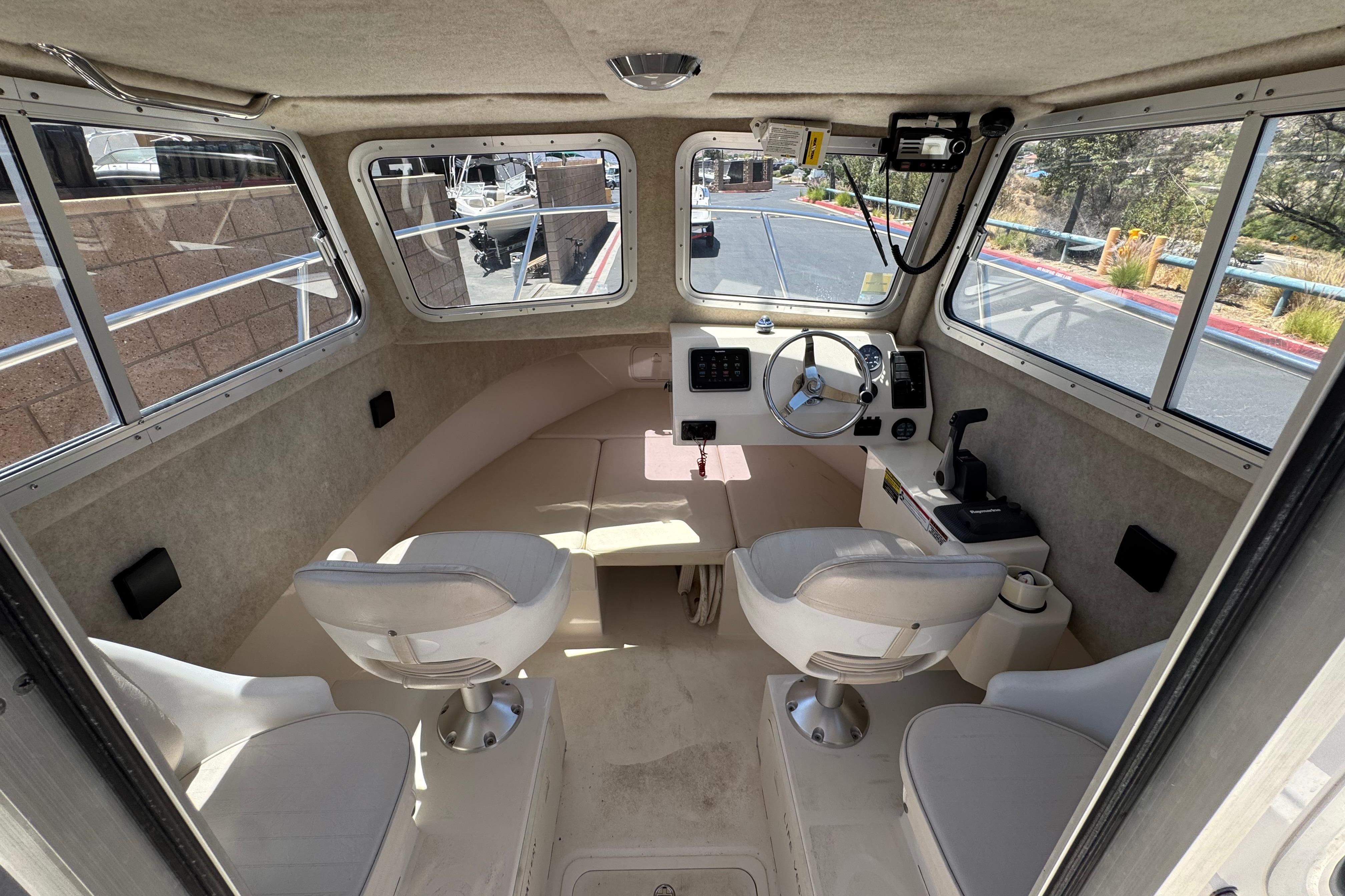 Interior of a 2017 Defiance Admiral 220 EX boat with helm and seating area.