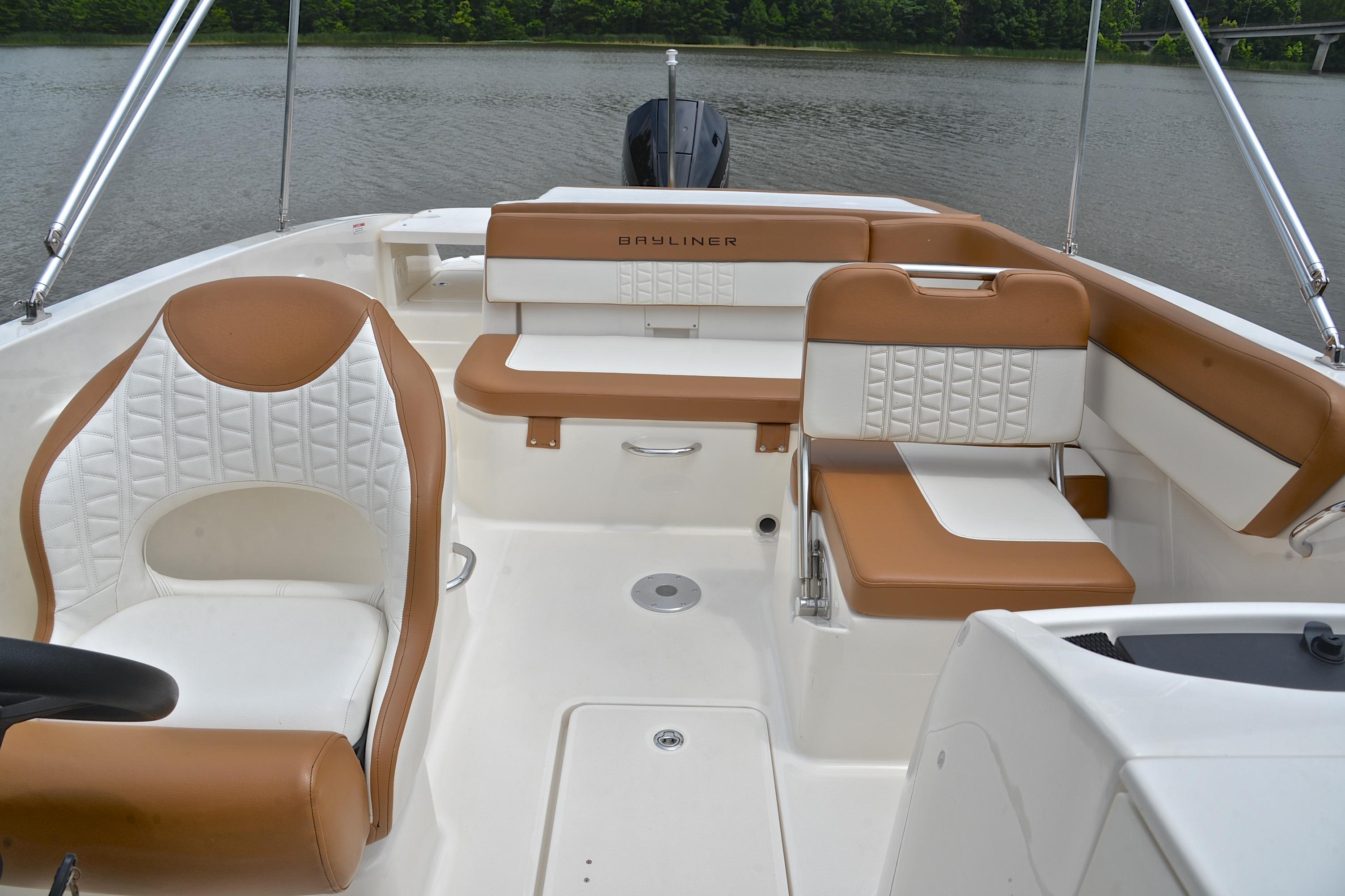2019 Bayliner VR6 Bowrider OB interior with tan and white seating, on a calm lake.