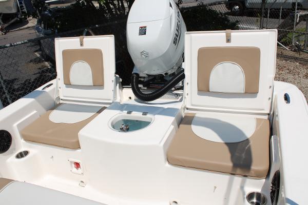 2023 Sundance DX20 boat interior with cushioned seats and motor.