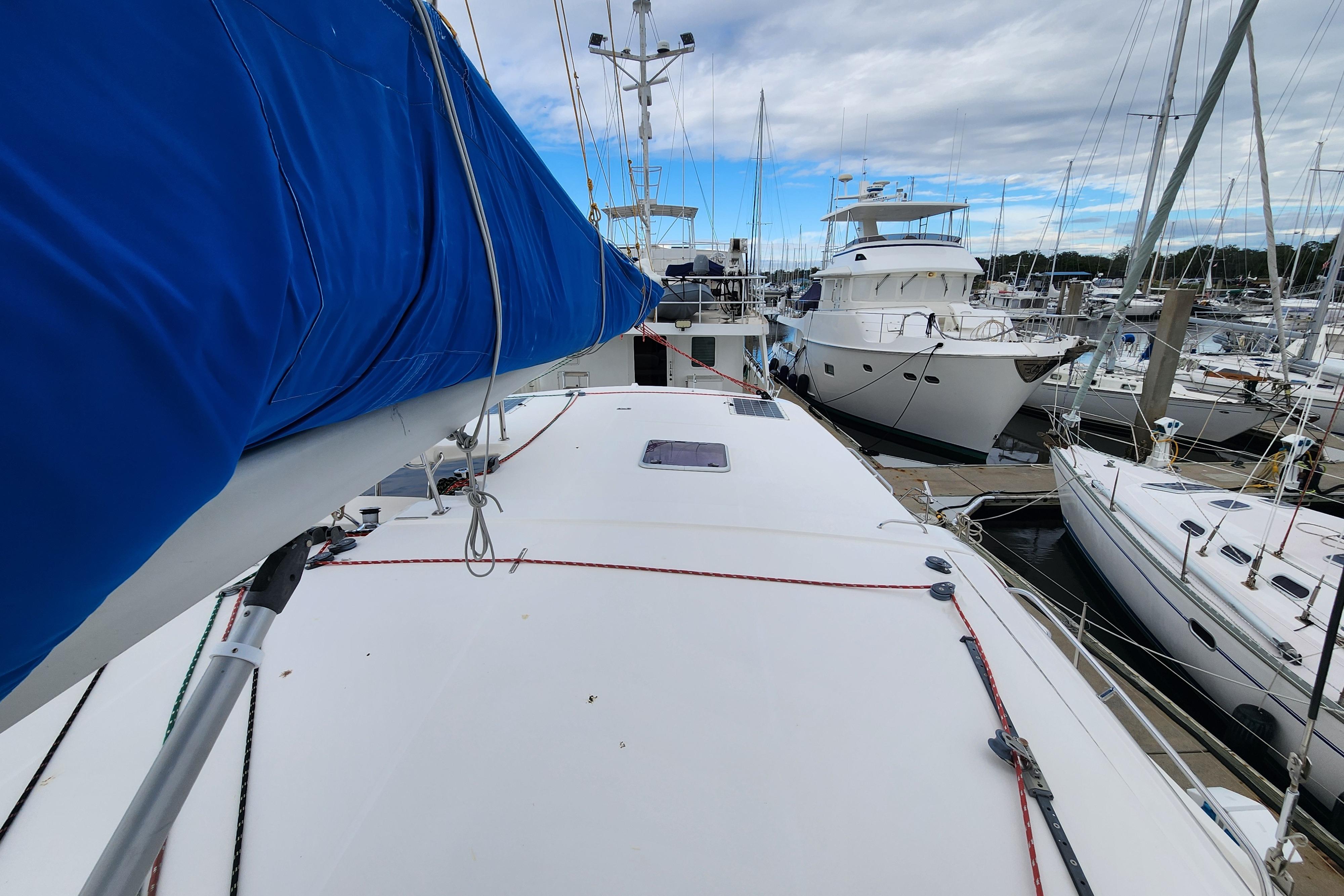 2015 Leopard 44 catamaran docked at marina, surrounded by other boats.