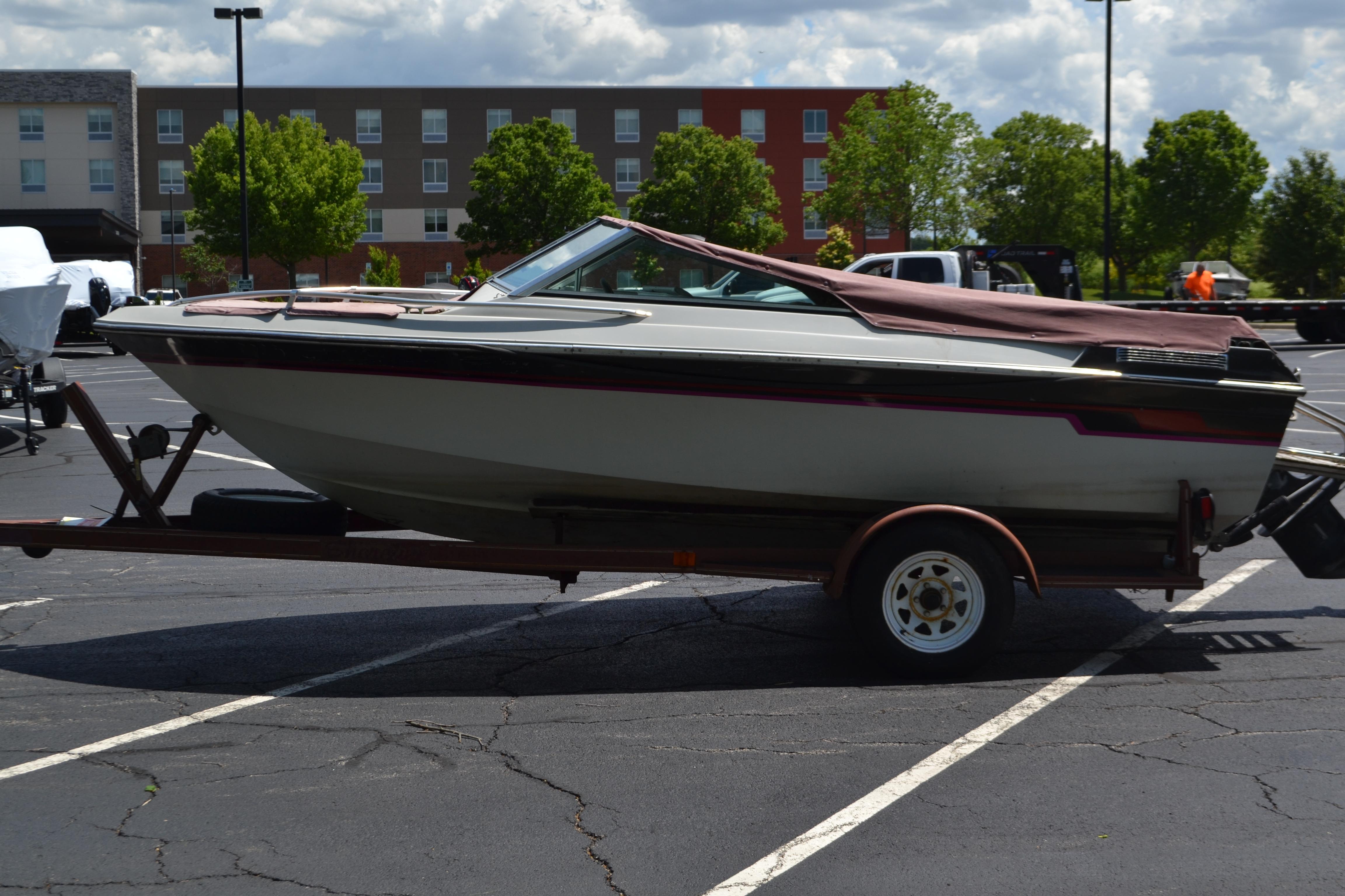 1985 Mach 1 MV 650 Eclipse boat on trailer in parking lot.