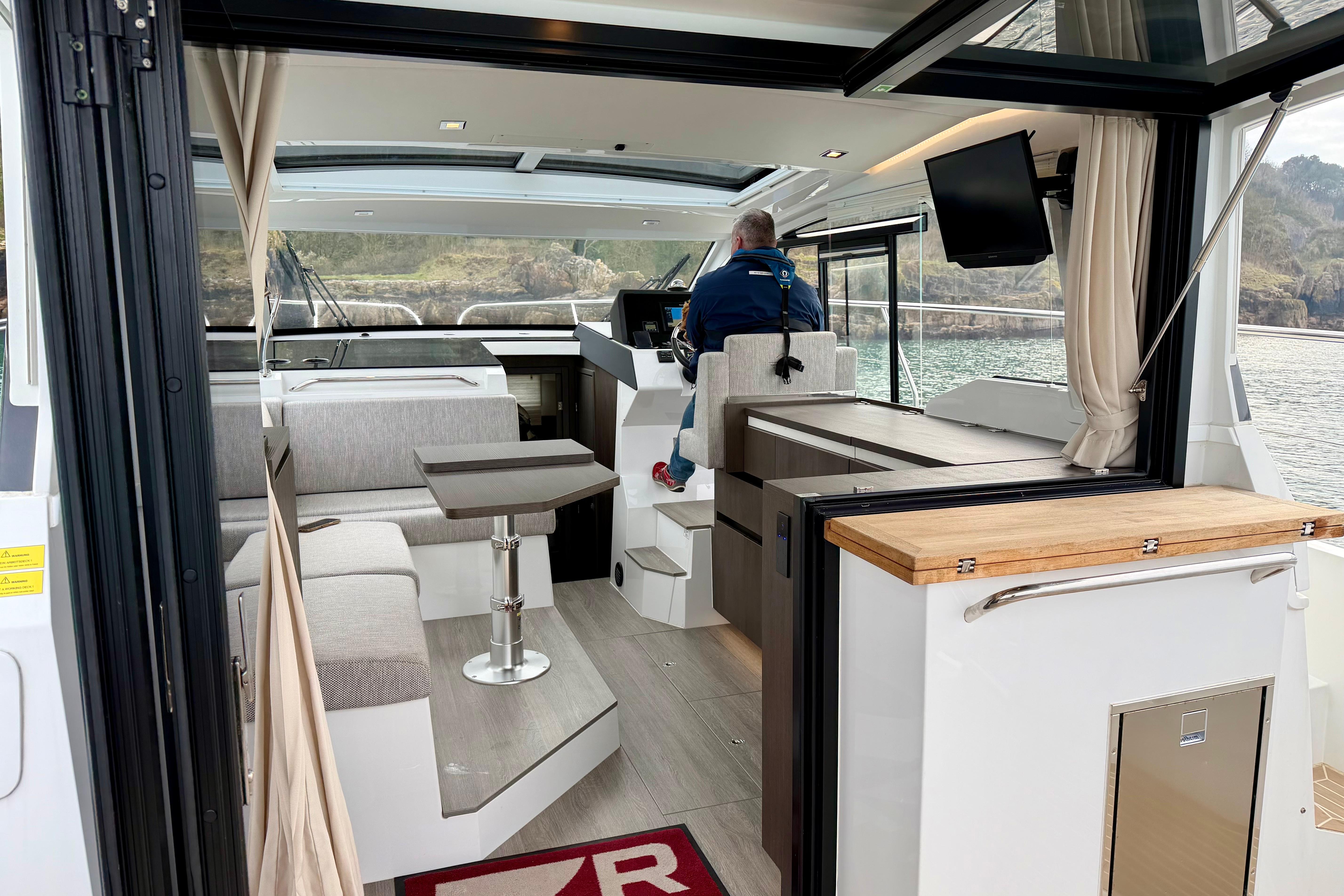 Interior of 2023 Sealine C335 yacht with modern seating and navigation area.