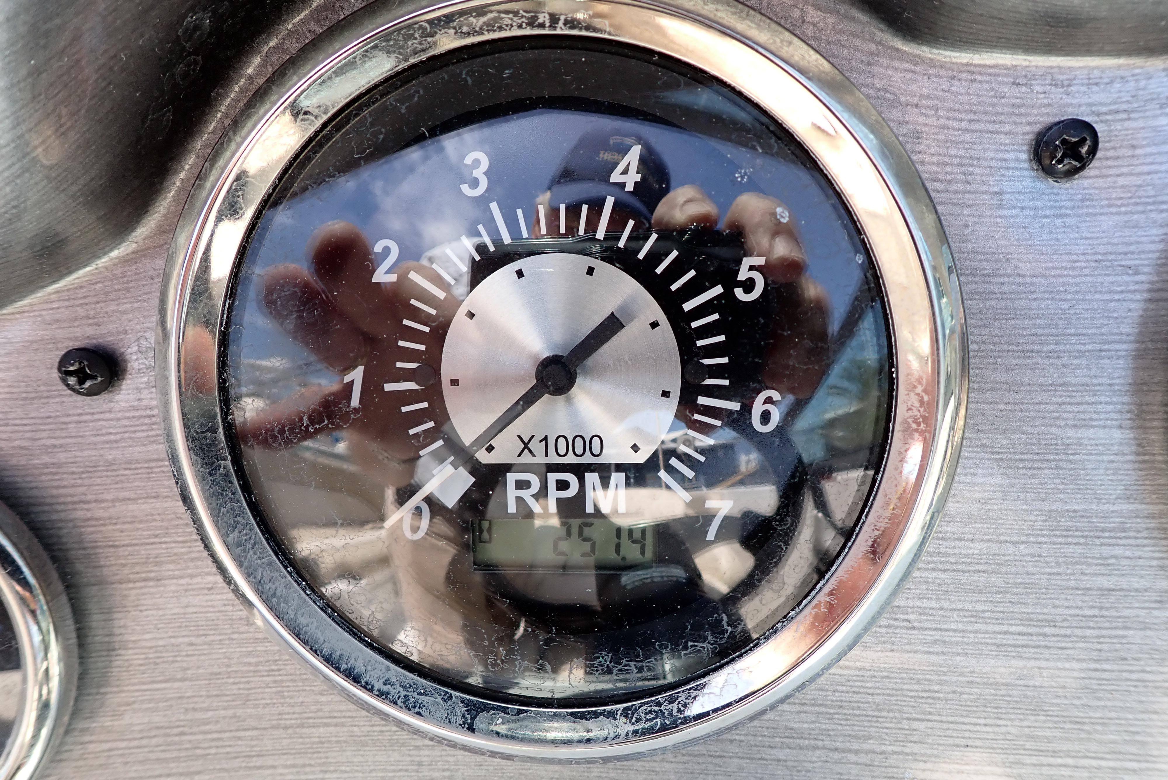 Tachometer of 2021 NauticStar 223 DC showing RPM with reflection.