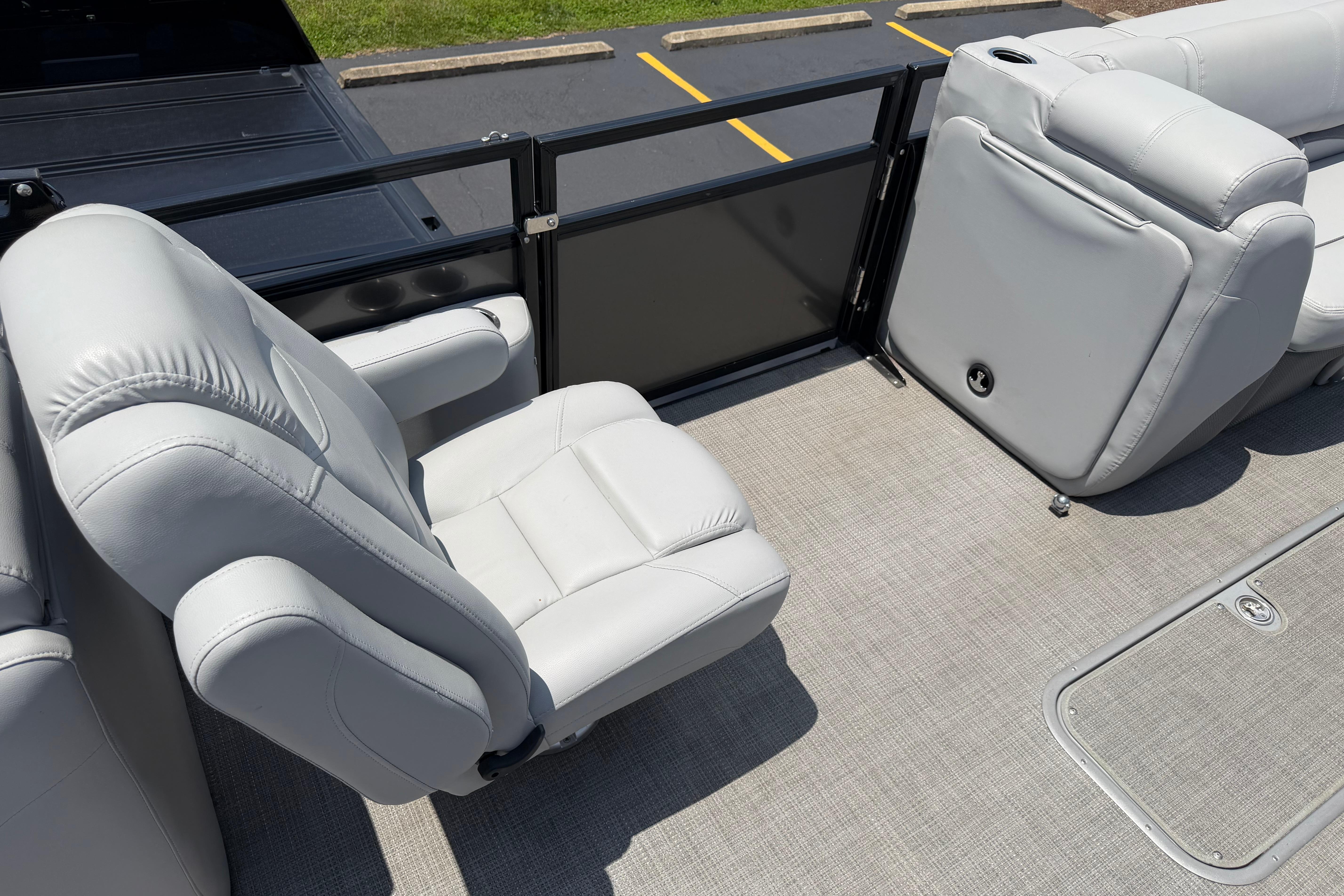 2019 Regency 230 DL3 boat interior with plush white seating and carpeted flooring.