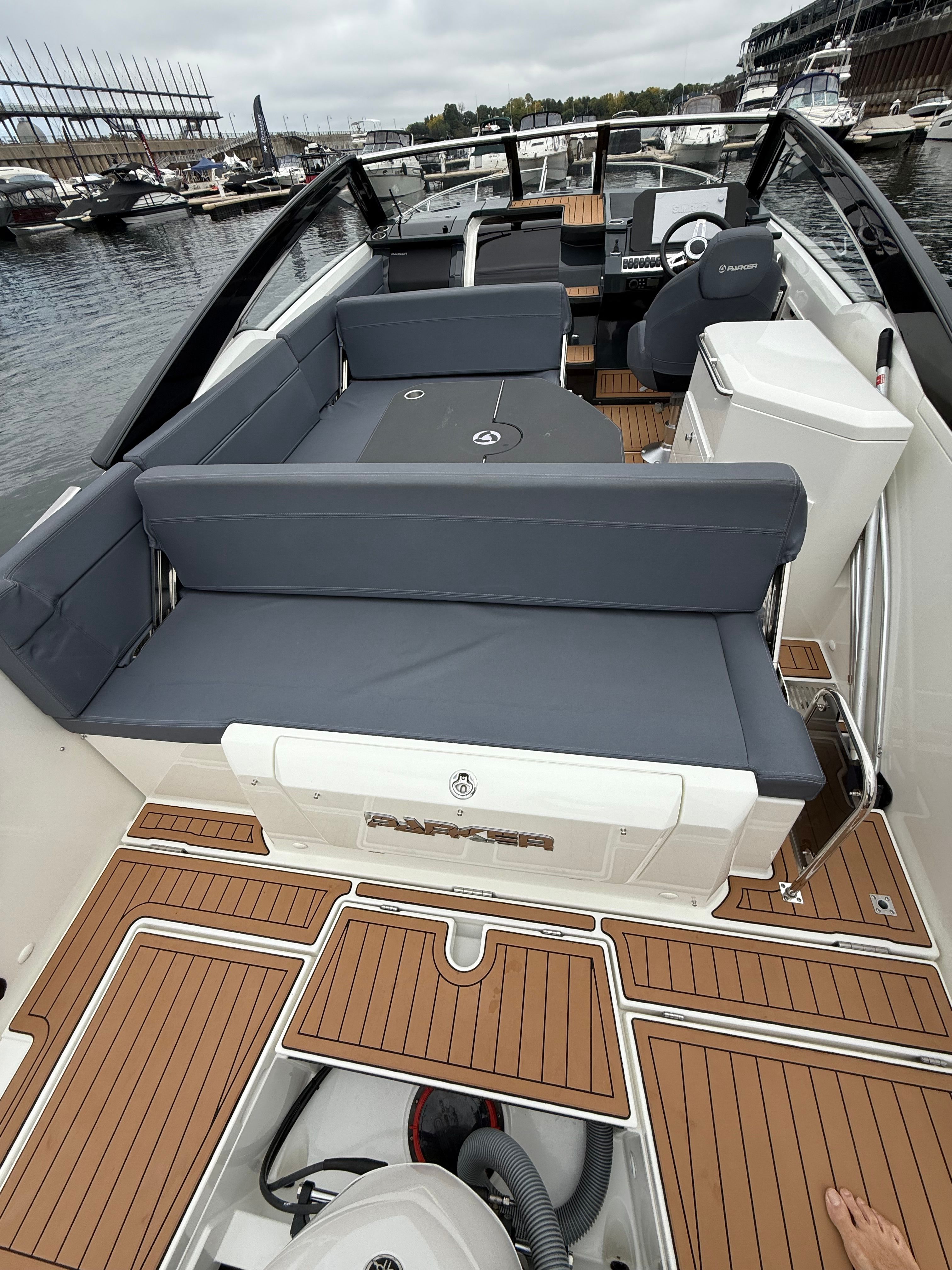 The image shows the deck of a 2022 Parker Poland 800 Cruiser with gray cushions.