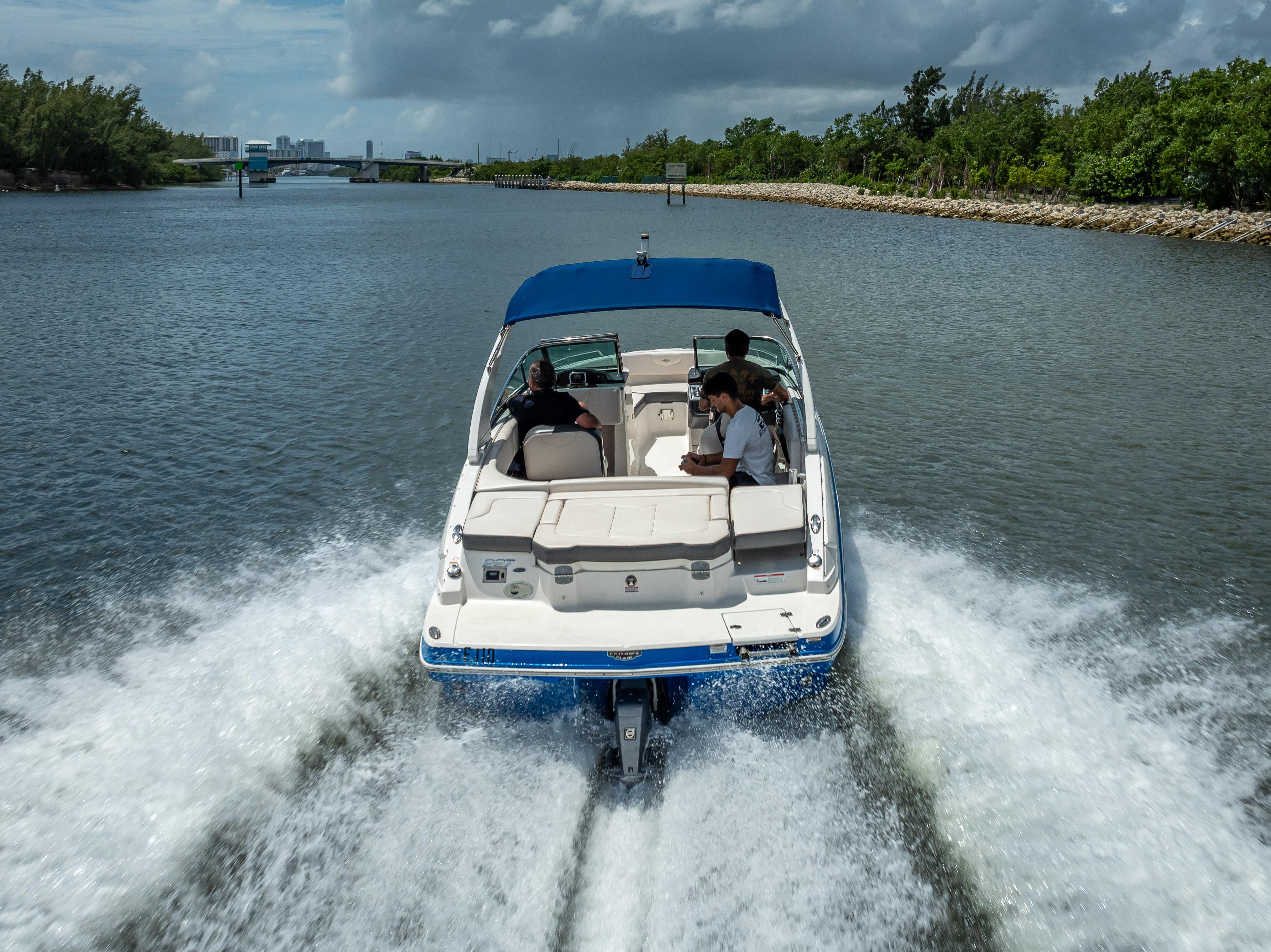 2017 Chaparral 227 SSX boat cruising on a scenic waterway with passengers onboard.
