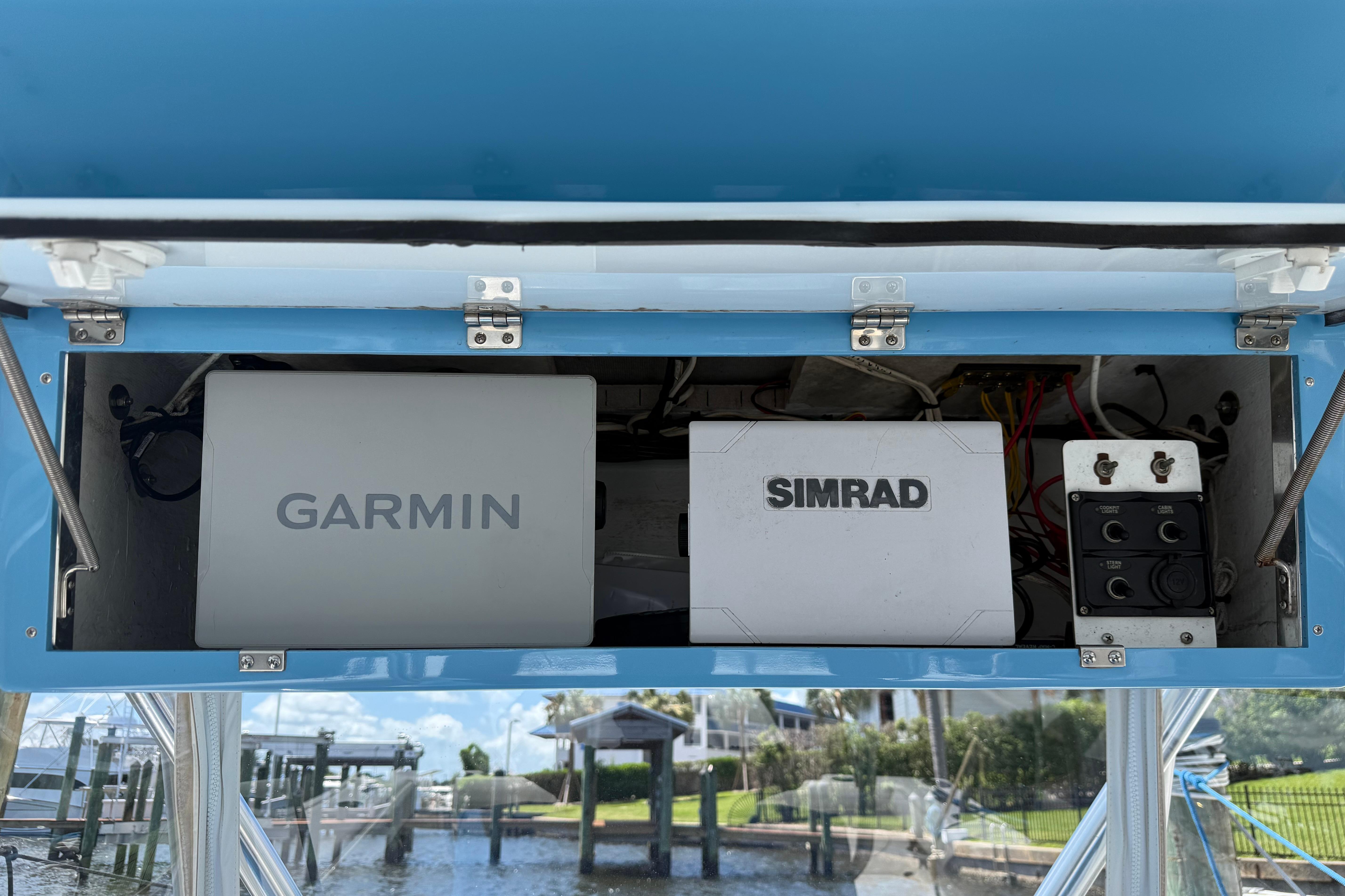 Electronics compartment of 1992 Intrepid 289 Center Console with Garmin and Simrad devices.