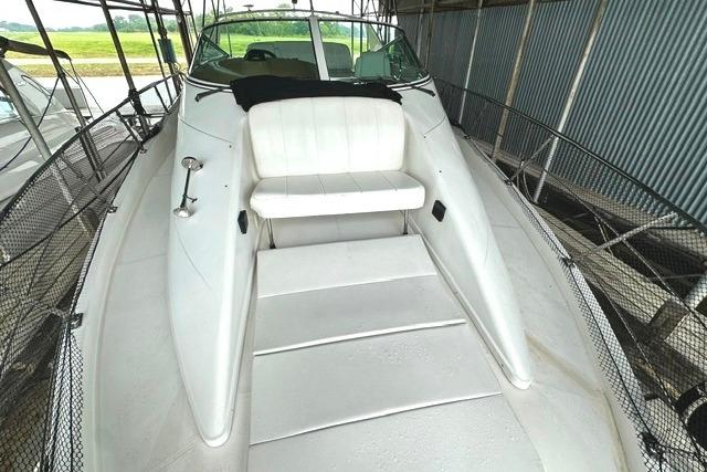 2004 Carver 360 Mariner boat with white seating and spacious deck in a covered dock.