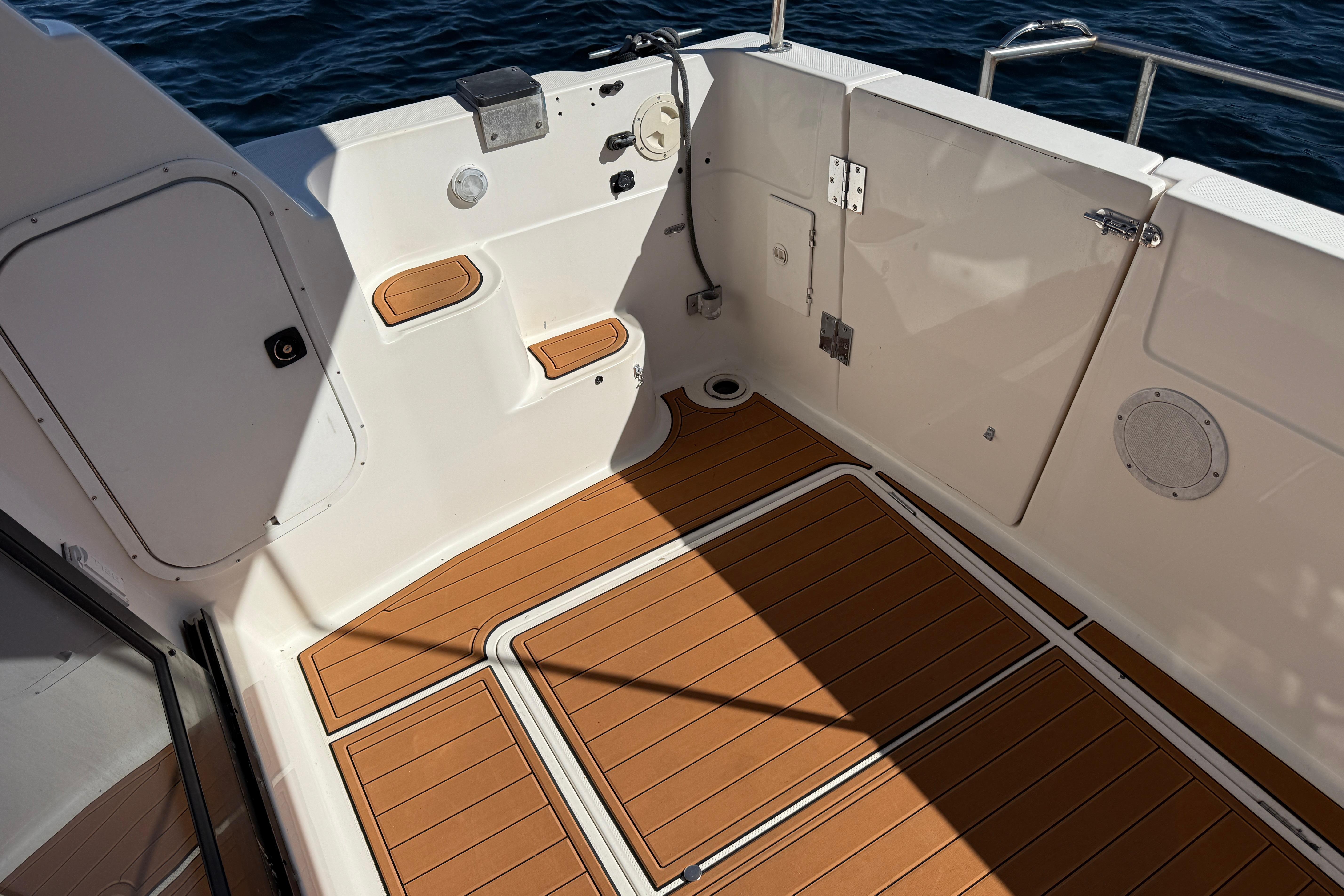 1997 Bayliner 3988 Command Bridge Motoryacht deck with teak flooring, overlooking the ocean.