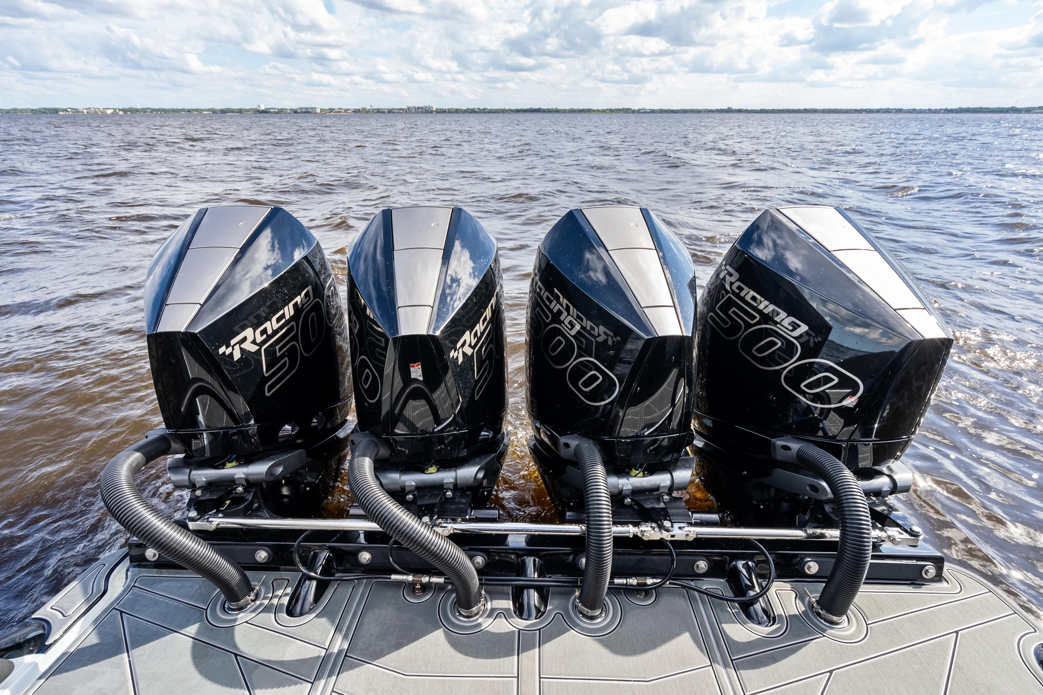Four powerful outboard engines on a 2027 Mystic Powerboats M4200, cruising on open water.