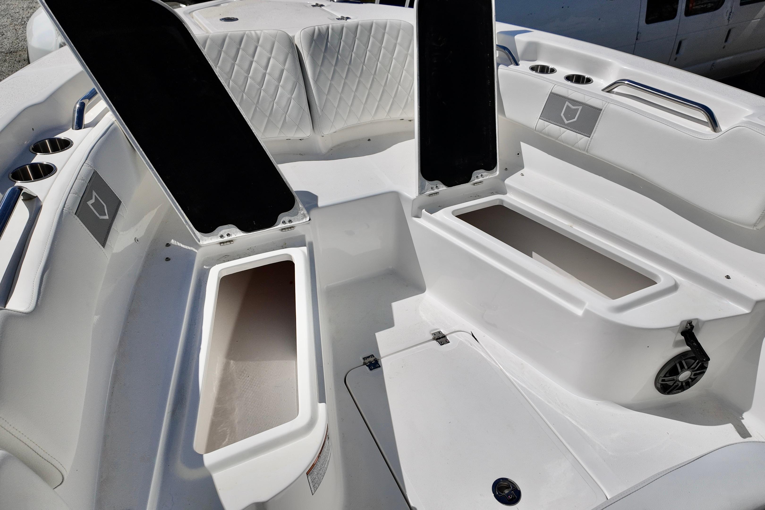 2026 Sea Fox 248 Commander boat interior with open storage compartments and cup holders.
