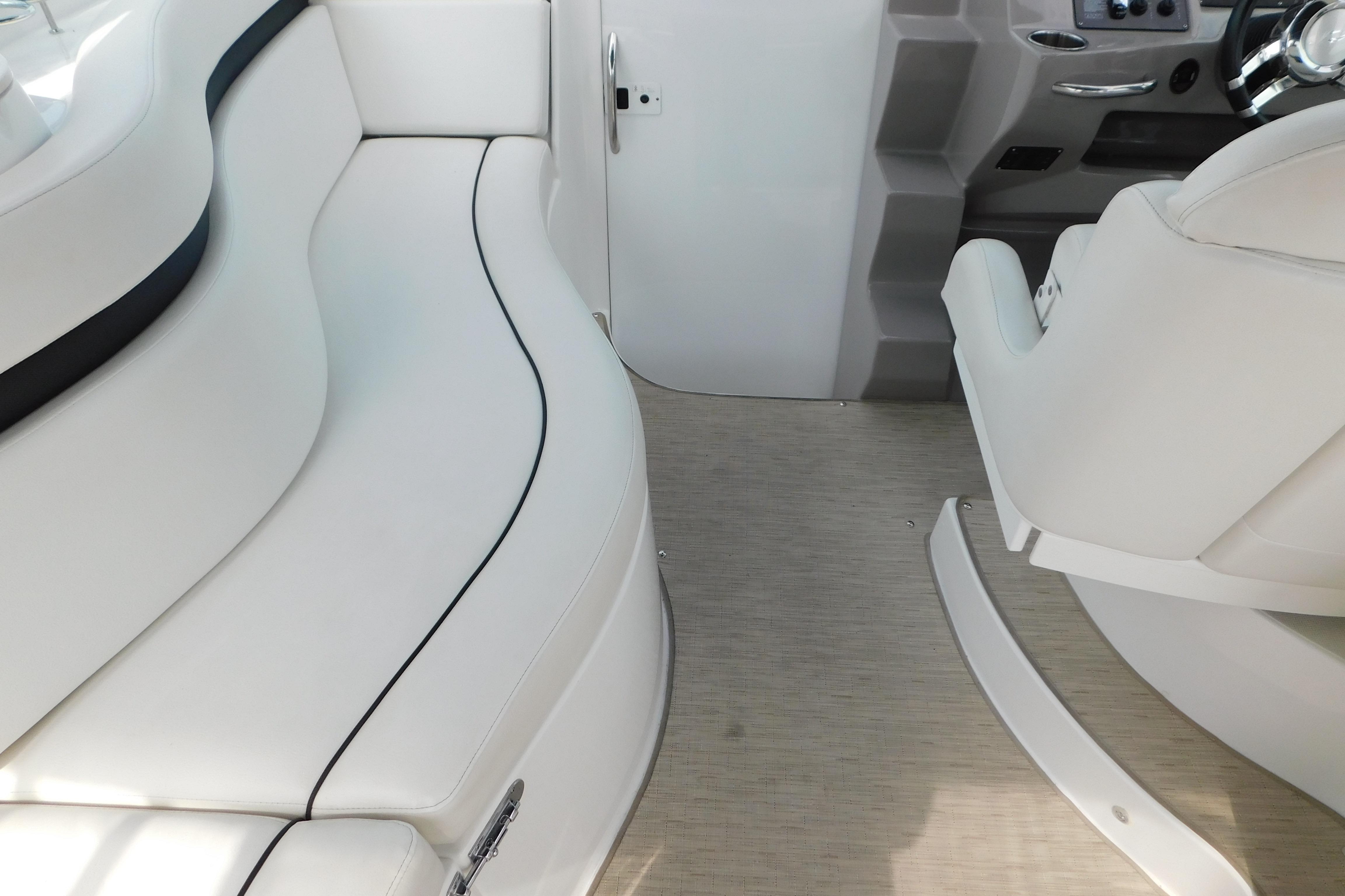 2017 Rinker EX 320 boat interior with white seating and helm area.