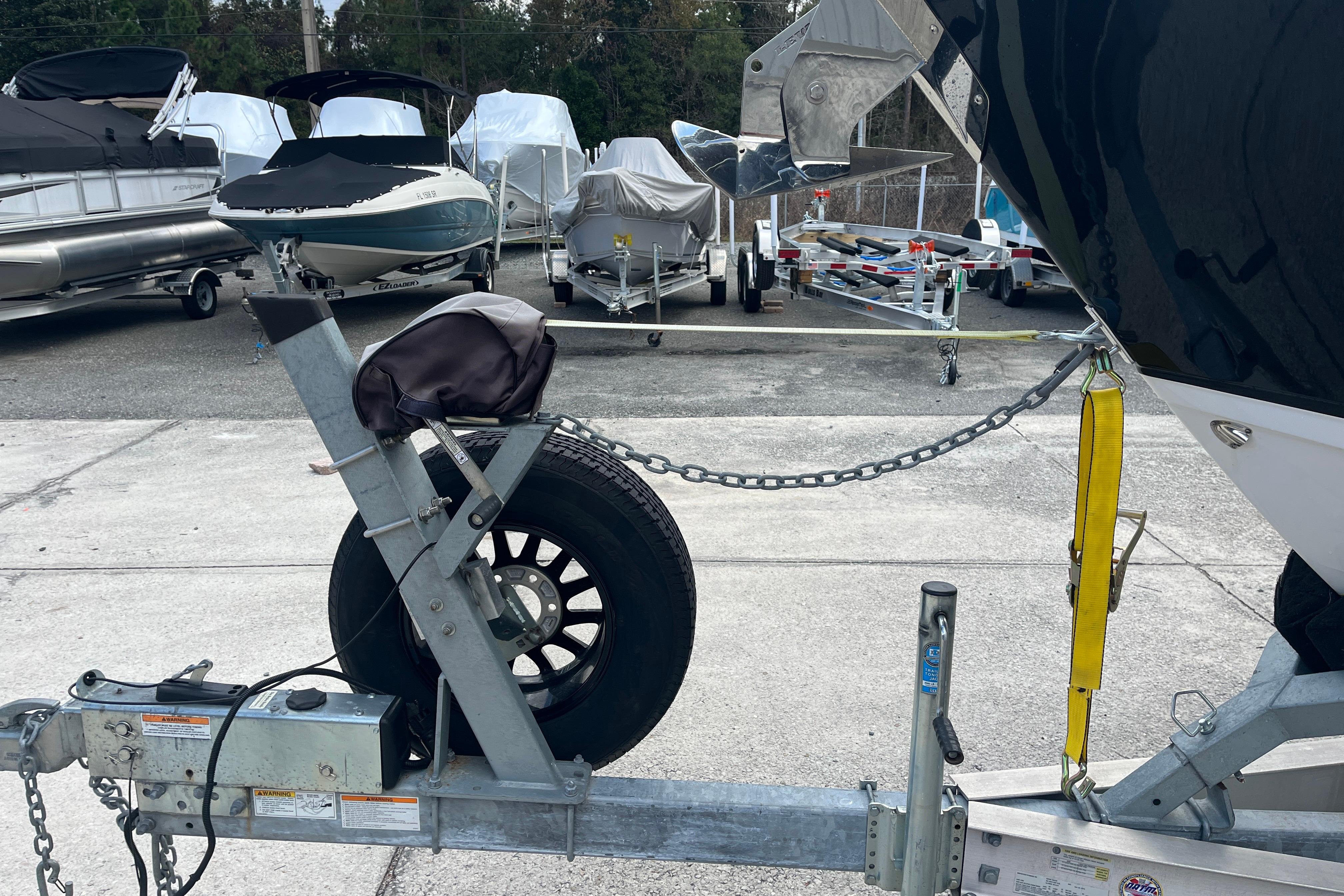 Boat trailer with Blackfin 252 CC, 2021 model, in a storage yard.