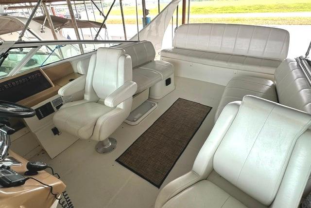 Interior of 2004 Carver 360 Mariner yacht with white leather seating and helm.