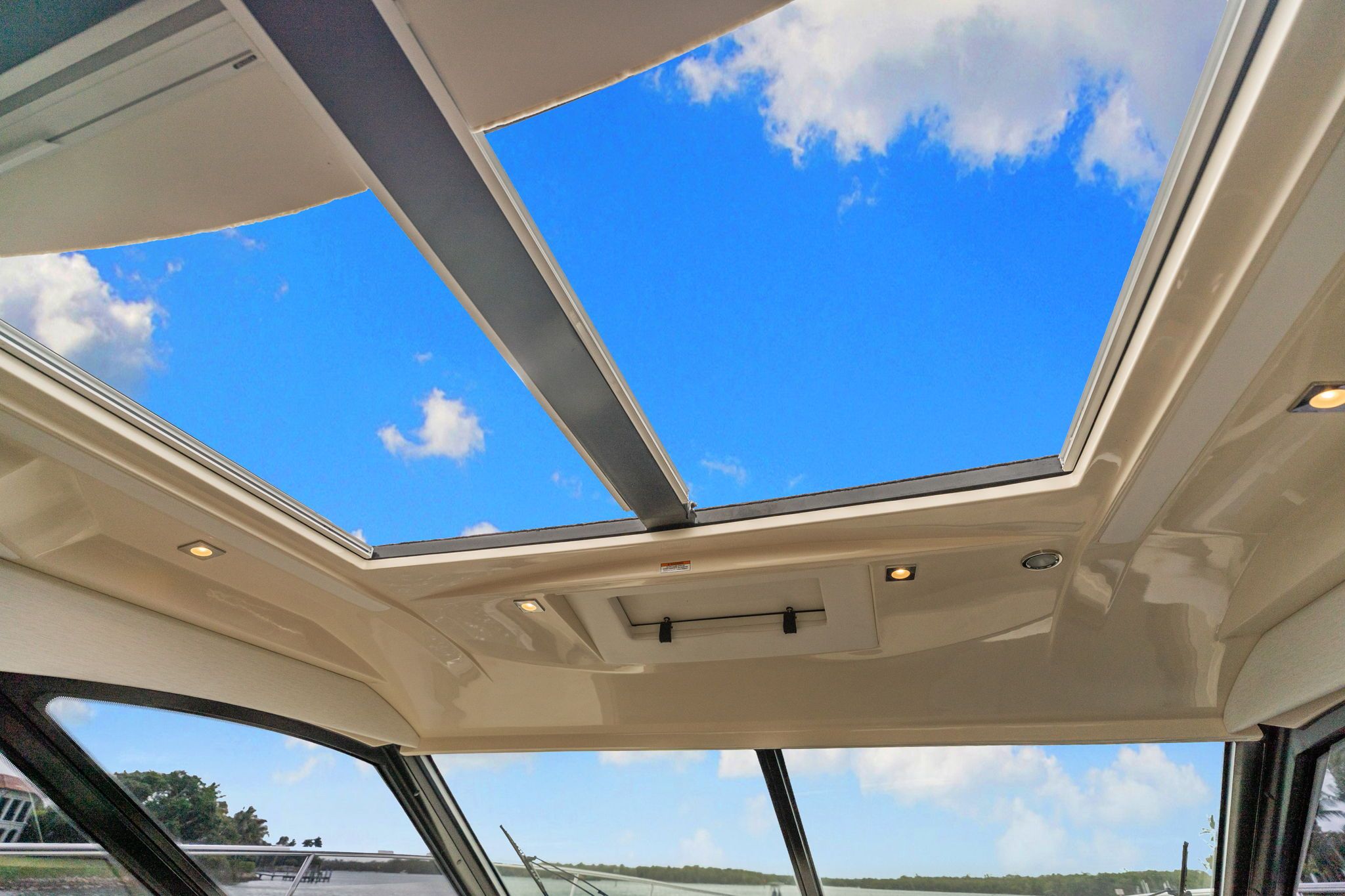 The image shows the sunroof of a 2017 Sea Ray Sundancer 510 with a blue sky.